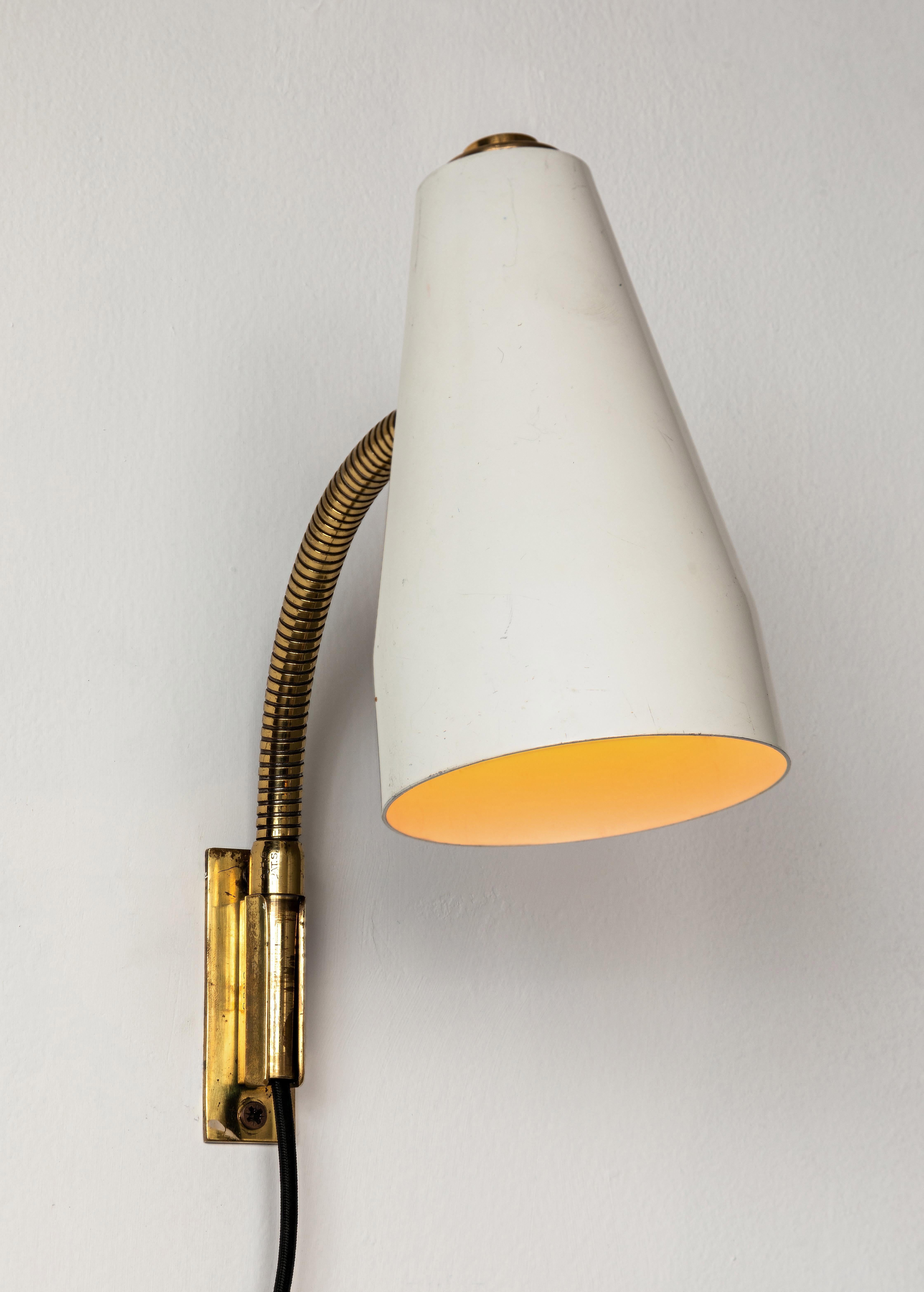 Pair of 1950s Lisa Johansson Pape Model #50-056/2 Wall Lights for Stockmann Orno. A highly versatile and adjustable pair of wall lights, the brass gooseneck arm with shade can be raised and lowered as well as rotated right and left. The articulating