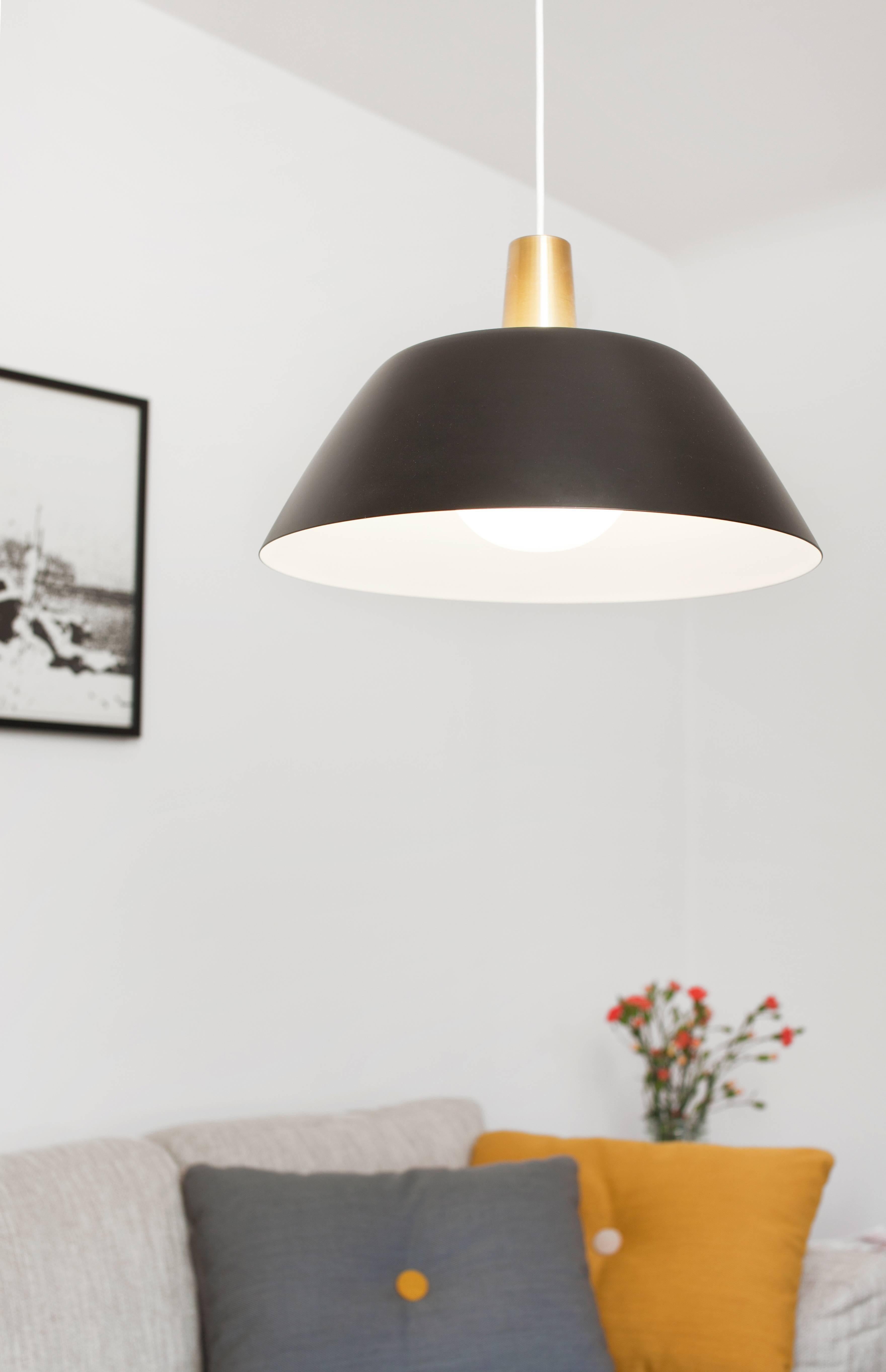 Pair of Lisa Johansson-Pape 'Ihanne' Pendant Lamps for Innolux Oy in Black

Originally designed in 1956, these authorized re-editions are true to the refined simplicity and detail of Pape's iconic original. The white interior of each metallic shade