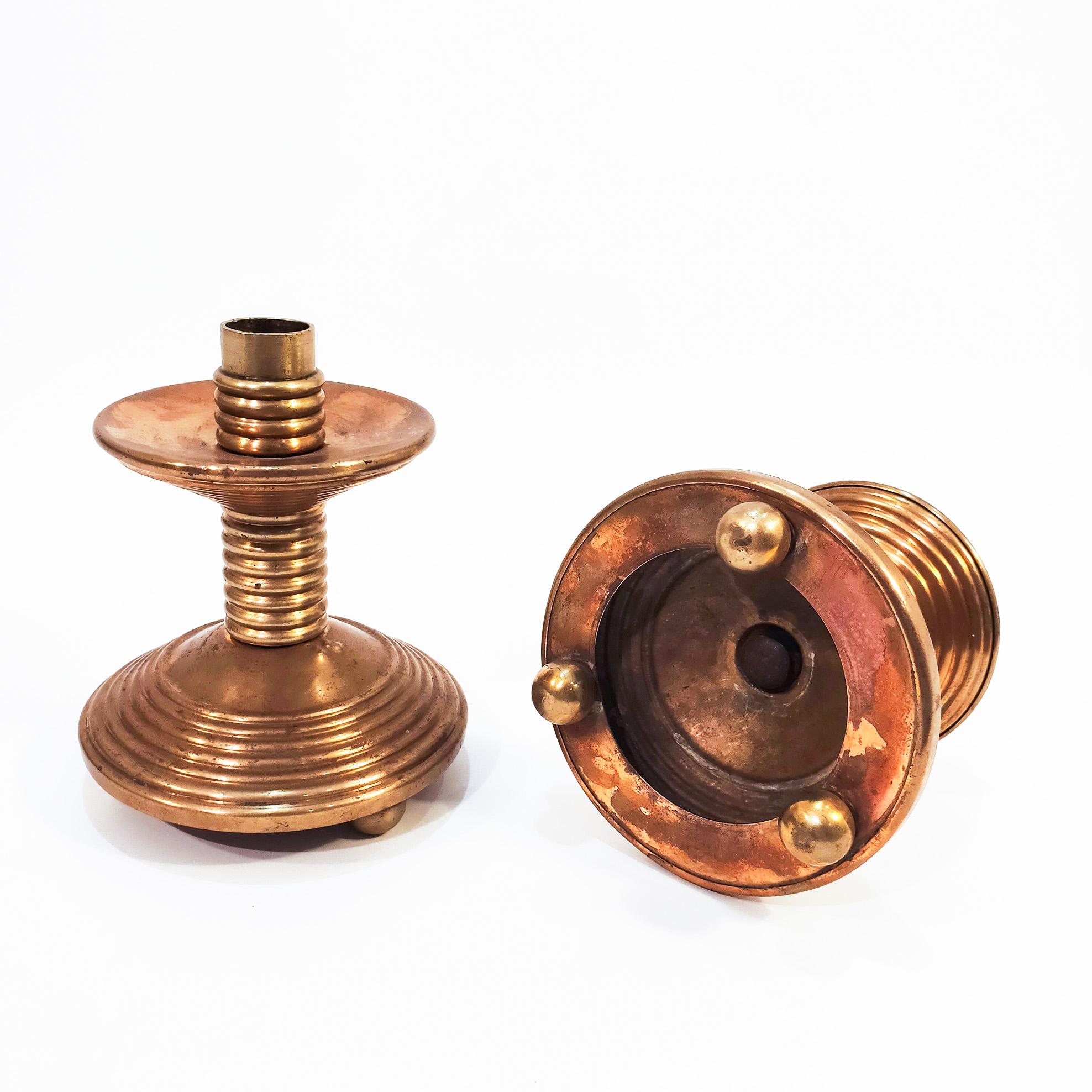 Pair of liturgical candleholders from the 30s, with a clear Art Deco and Cubist influence. Made of brass, with patina and signs of the use and time. Some little dents.
