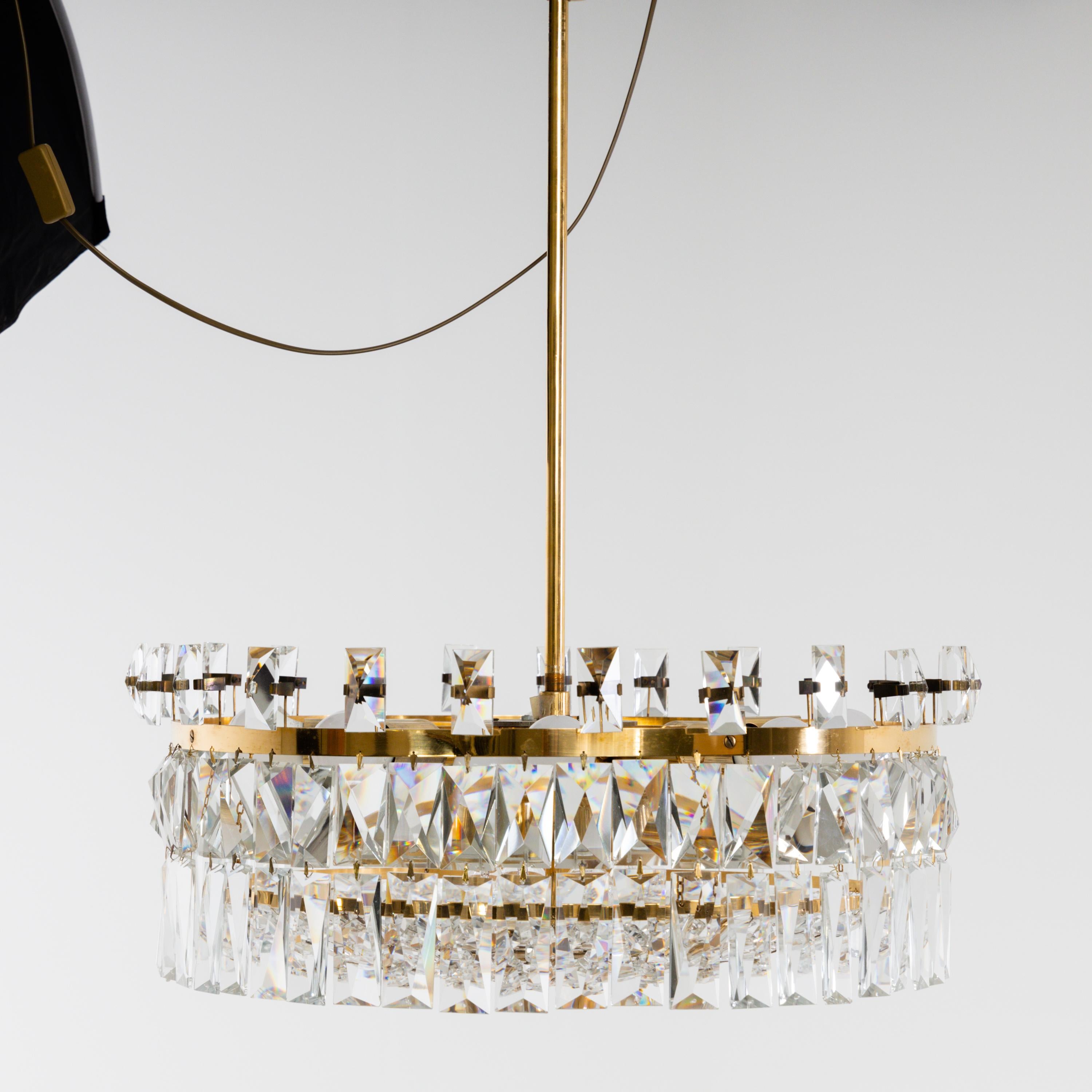 Large two-tier Lobmeyr chandeliers with cut crystal hangings on narrow brass hoops. The model was originally designed for the Markthalle Feldkirch in 1972.