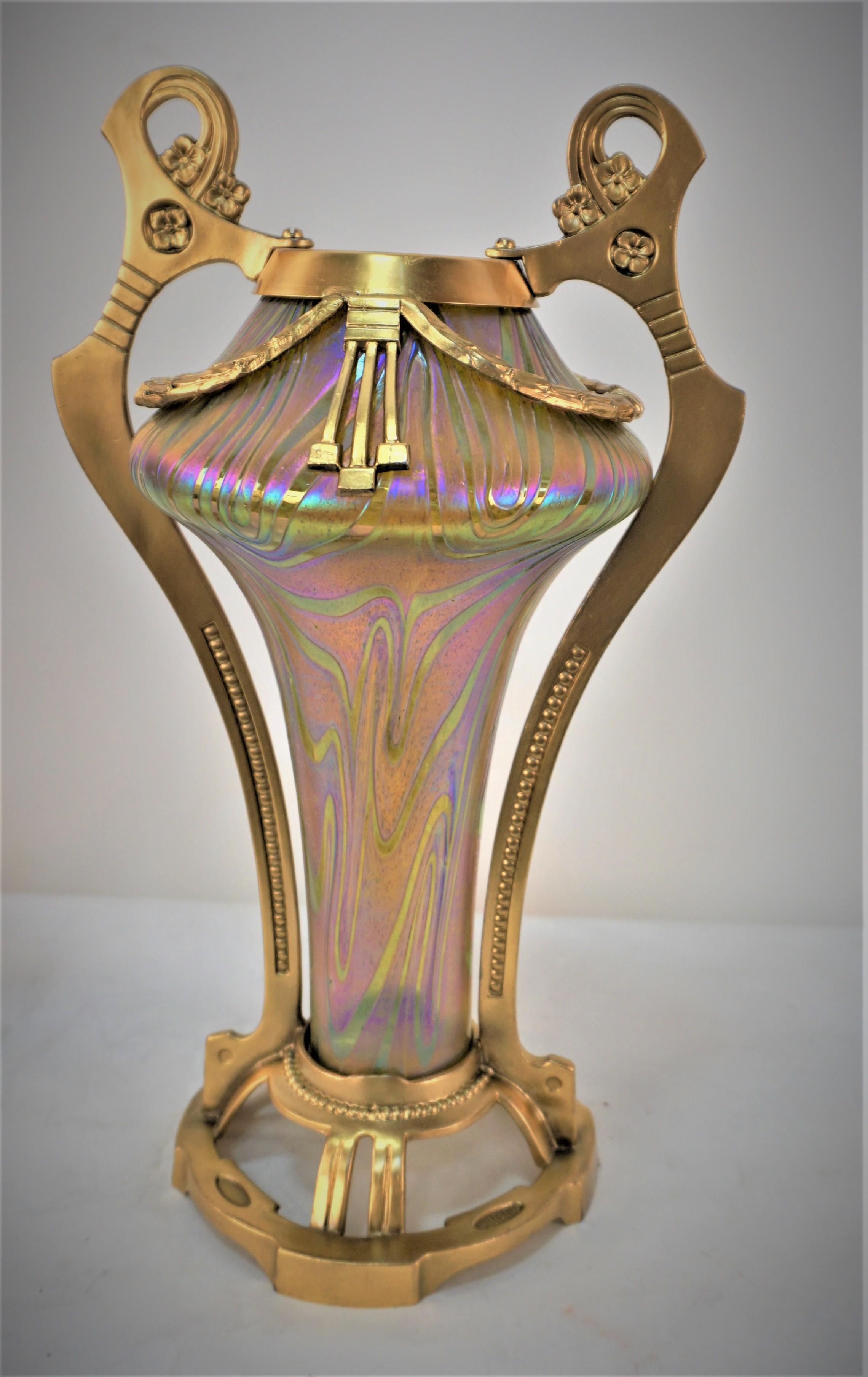 Beautiful pair of iridescent green, yellow and gold glass vases with gilt metal frame.
