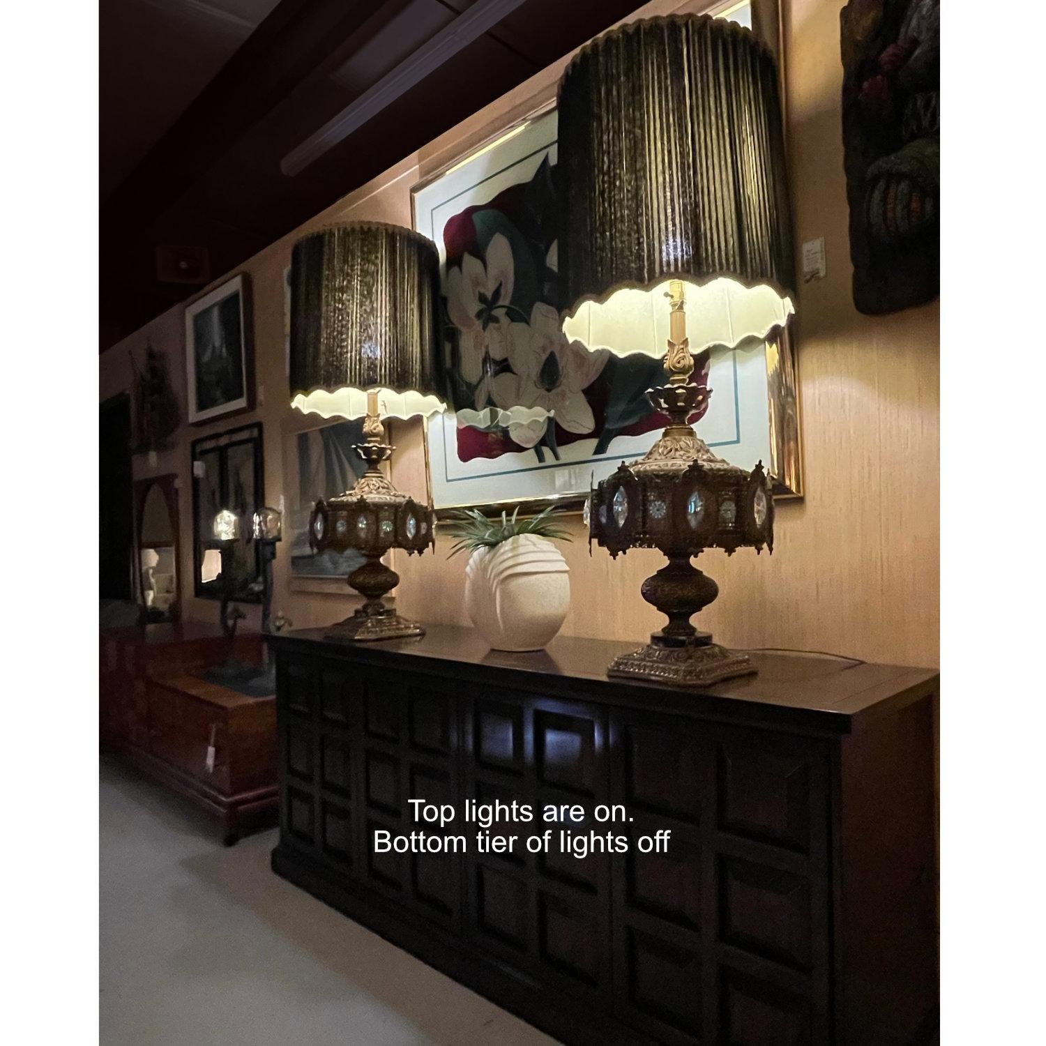 Elaborately embossed Hollywood Regency lamps by Loevsky & Loevsky. Loevsky & Loevsky, also known as L&L WMC, was based in New Jersey during the mid-20th Century. These extraordinary lamps feature Baroque inspired stamped patterns throughout the