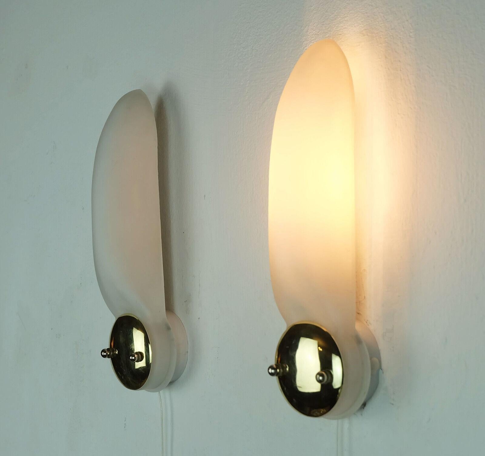 Pair of 1990s sconces manufactured by Honsel. Matt white opaline glass shades with brass details, base white lacquered metal. Holds 1 E14 light bulb each.

Dimensions in cm: 
Length 29 cm, width 8 cm, depth 8 cm.

Dimensions in inches:
Length