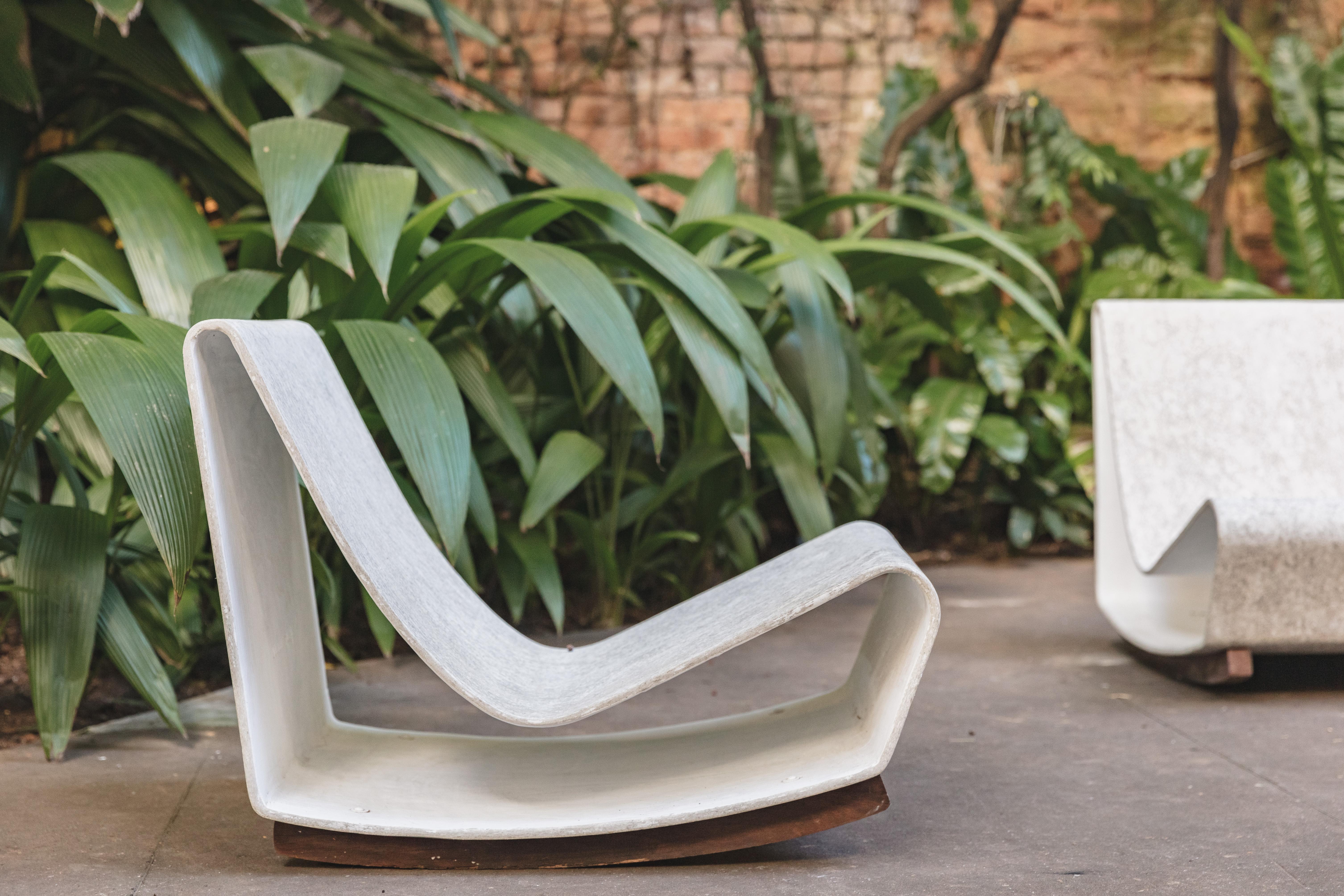 Pair of chairs designed by Willy Guhl with a shape of a loop, featuring a single volume of seats and backs. The Loop chair is suitable for both indoor and outdoor use. The “Loop Chair” was created in 1954 after Guhl watched as the Eternit panels