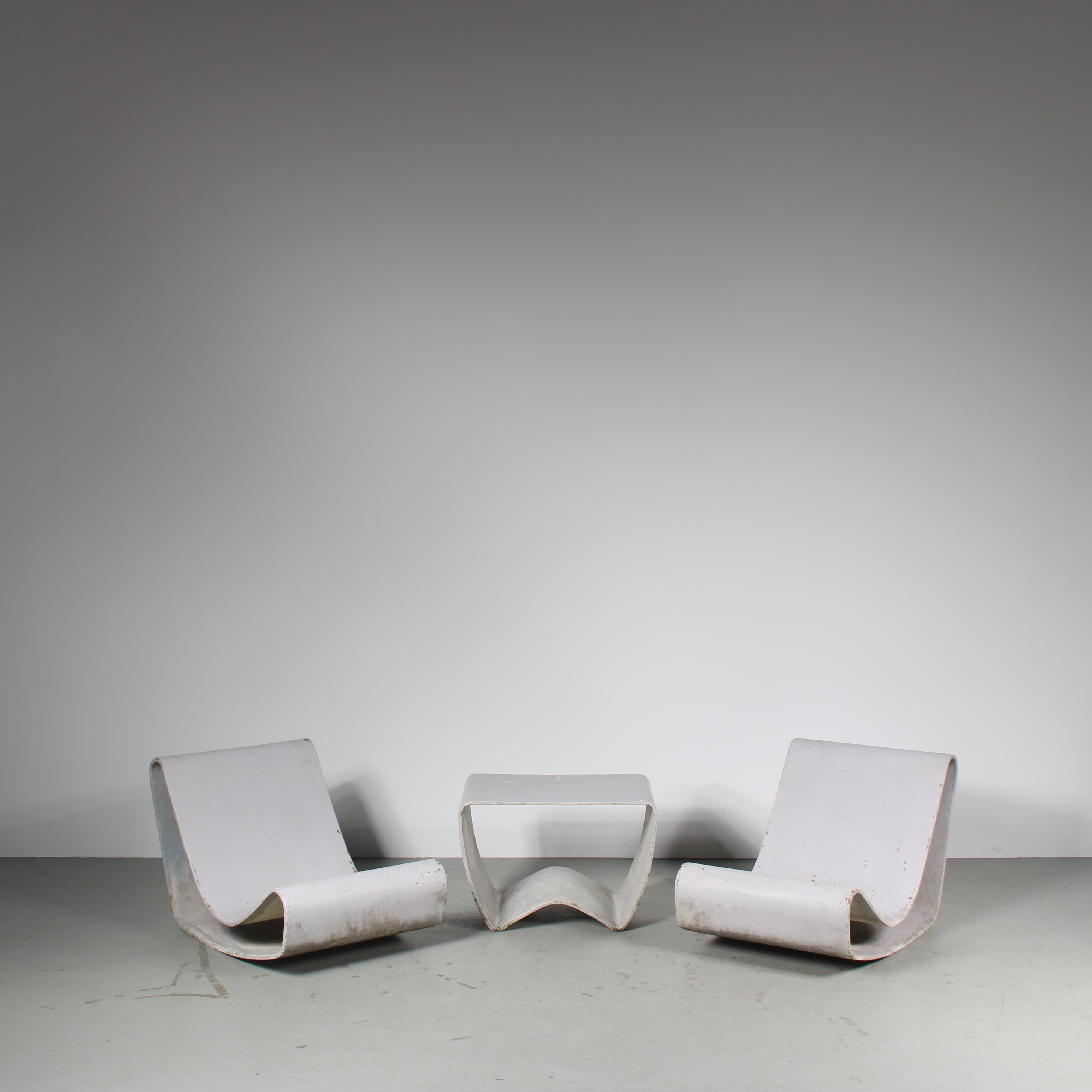 A fantastic set of two “Loop” chairs and a matching table designed by Willy Guhl, manufactured by Eternit in Switzerland around 1950.

The Loop chair is a classic piece of mid-century design, iconic since it’s first design in 1954 and still much