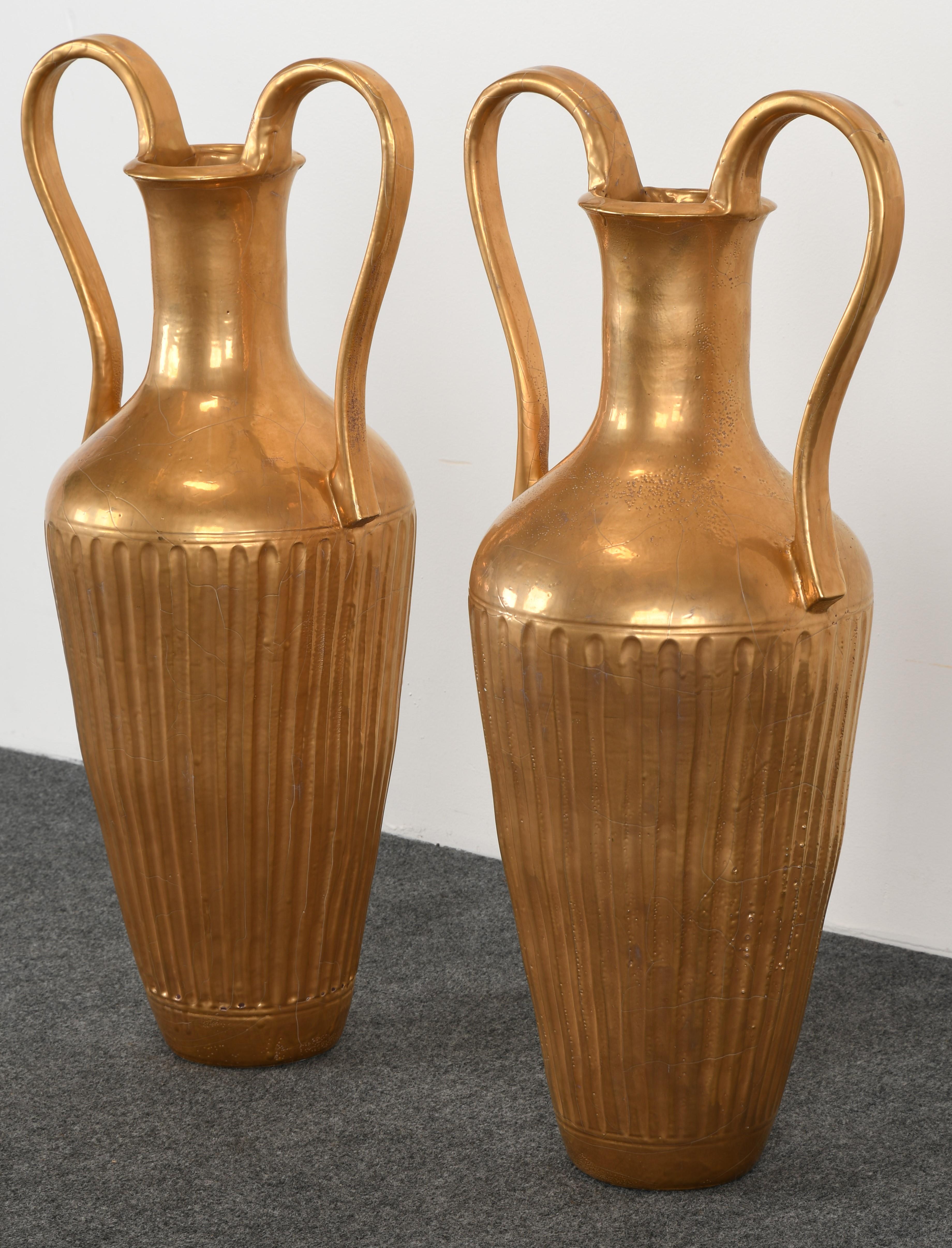 A pair of Lorin Marsh gilt Etruscan floor vases or urns. Original paper label on top-side of urn signed 