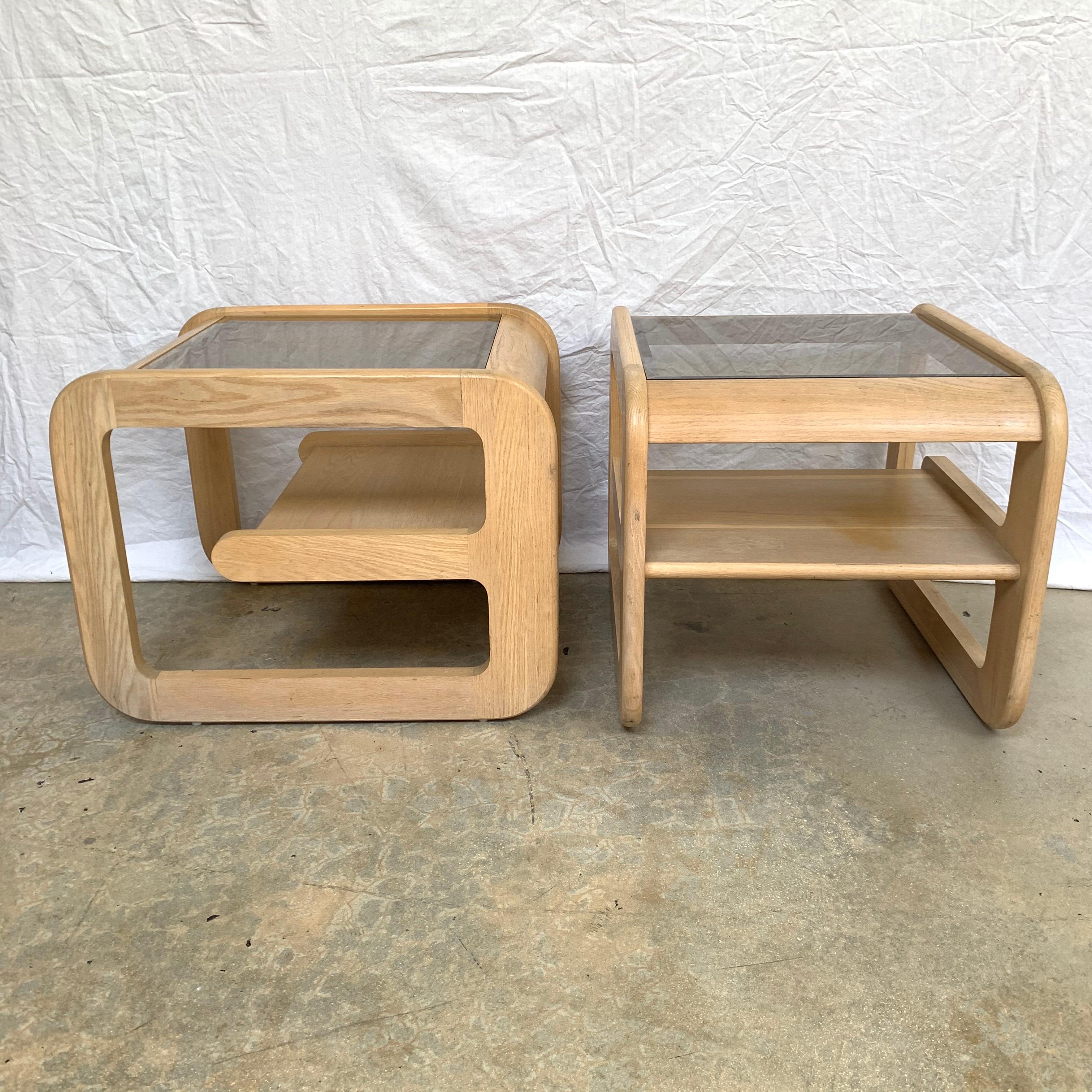 Sculptural pair of organic California modern end or side tables rendered in an original bleached white oak finish with smoked beveled glass tops and in internal oak shelf by Mersman, USA, 1970s.