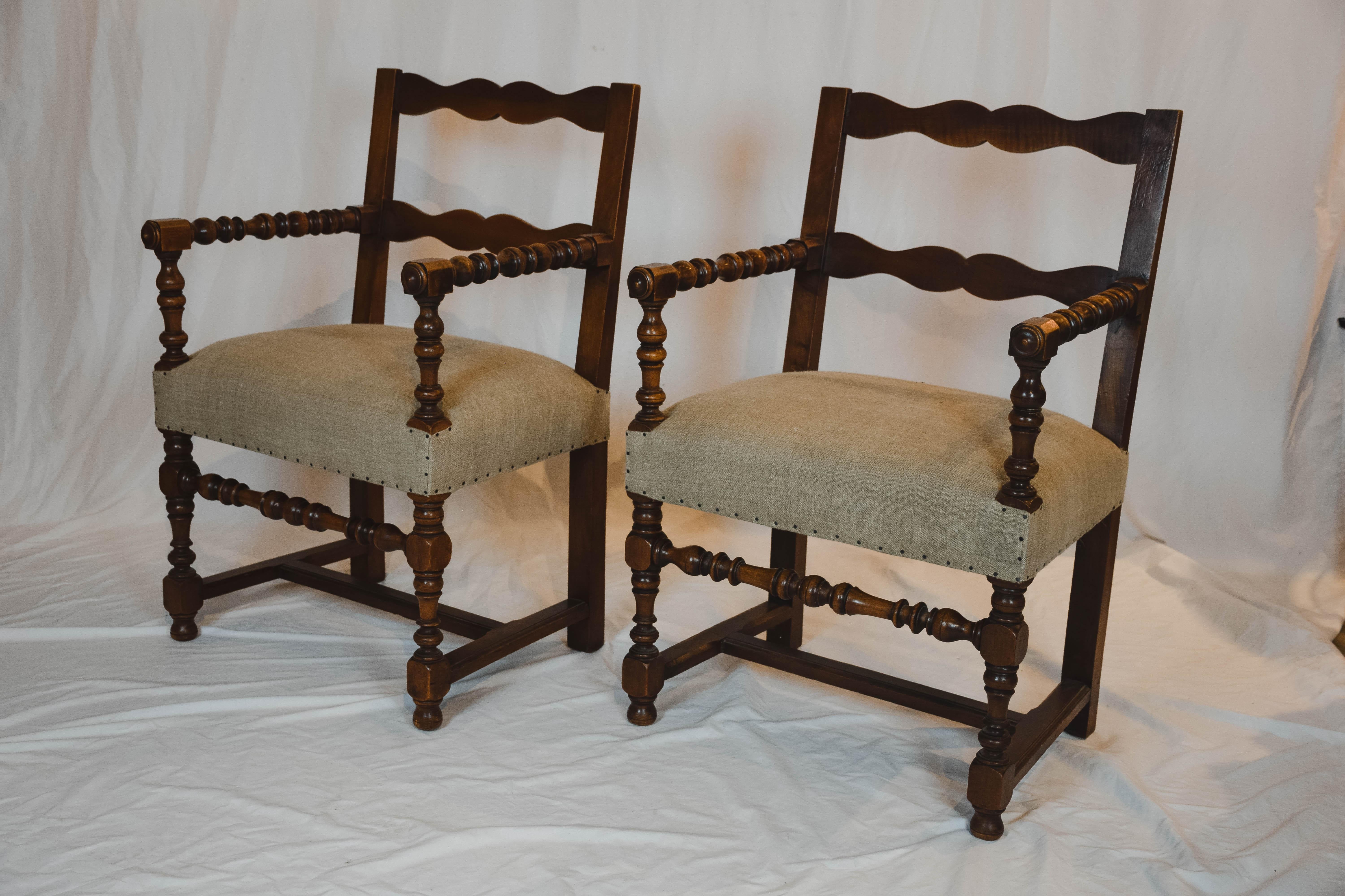 Wonderful pair of Napoleon III chairs found in Southern France. This sturdy pair of fauteuil have beautiful turned legs and arms and a ribbon shaped slatted back. The chairs have been newly upholstered in a Belgian Linen fabric.