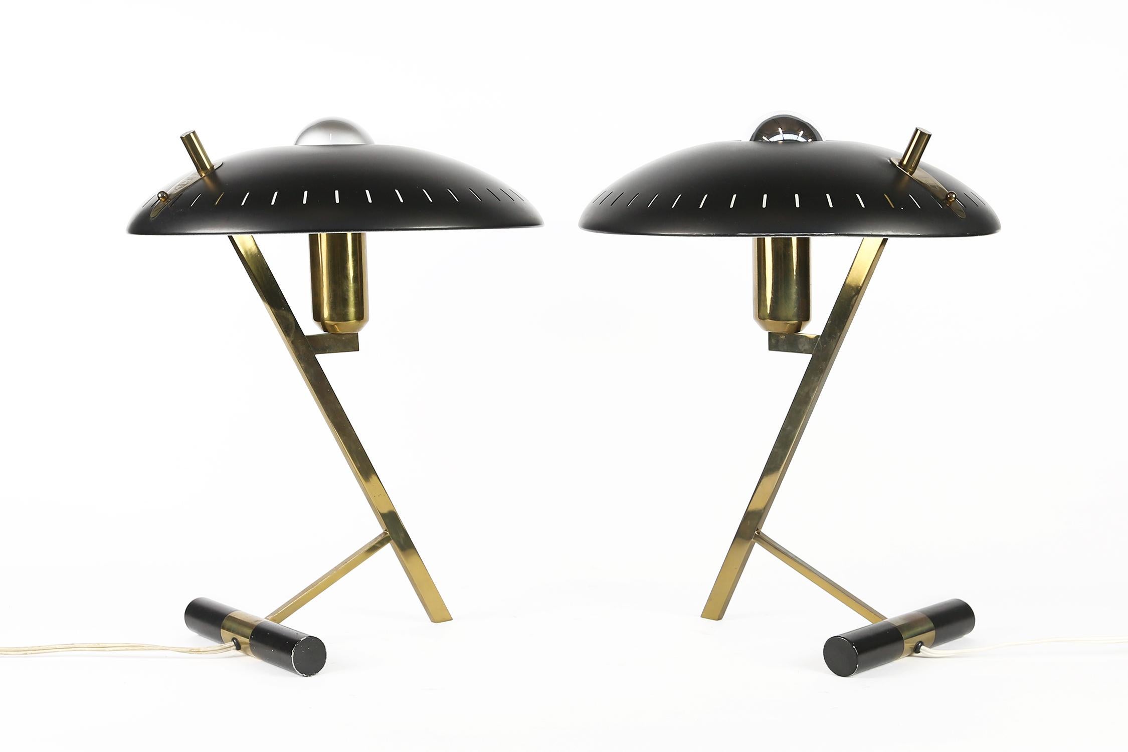 An iconic Dutch-Industrial desk or table lamp designed by designer and architect Louis Kalff; for the Philips Company, Holland, 1955.
This is the first edition with a brass frame and the black disk-shaped perforated black lacquered shade. The shade