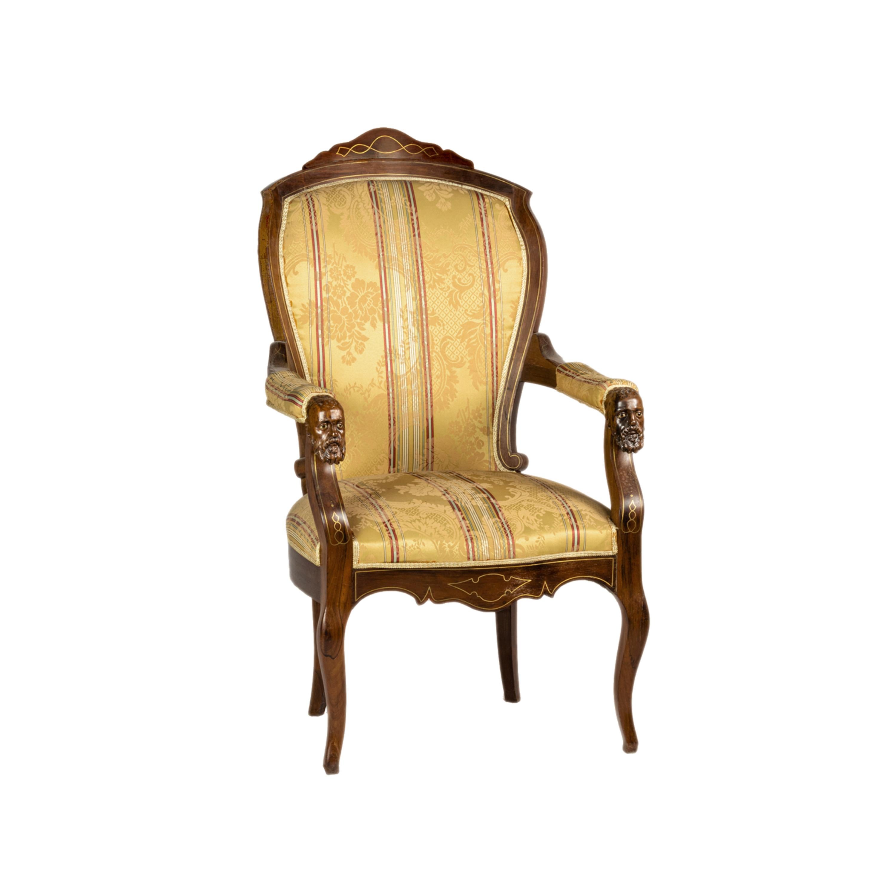 A pair of two large and wide armchairs: rare and in pristine conditions pair of Voltaire armchairs, richly carved armrests with male beard faces in orientalistic style.  An impeccably maintained luxury yellow upholstery, yellow marquetry “thread”