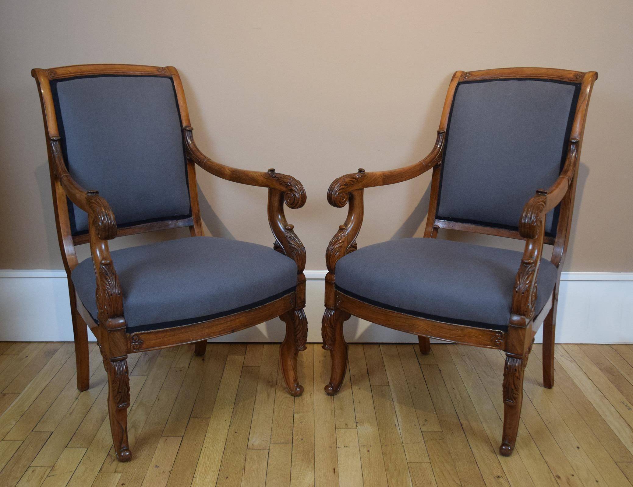 This comfortable, superbly carved pair of Louis-Philippe armchairs is unusual in having been made of rosewood, an exotic timber that was rare in France at the 1840s. It is now upholstered in grey felt with black gimp. 

The chairs come from the