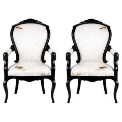 Paire de fauteuils Louis Philippe en laque noire Noyer 19ème siècle Faces sculptées