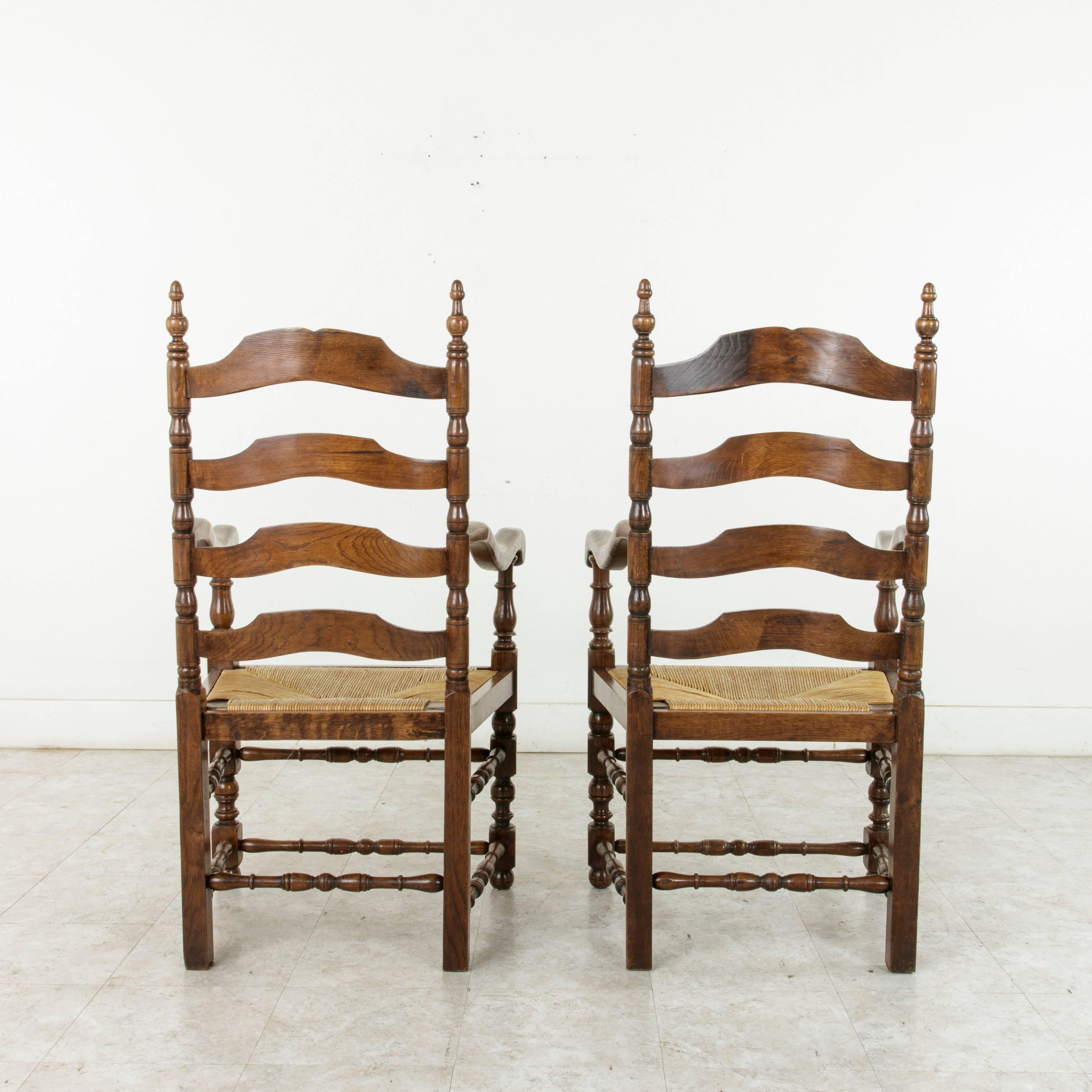 20th Century Pair of Louis Philippe Style French Oak Ladder Back Armchairs with Rush Seats