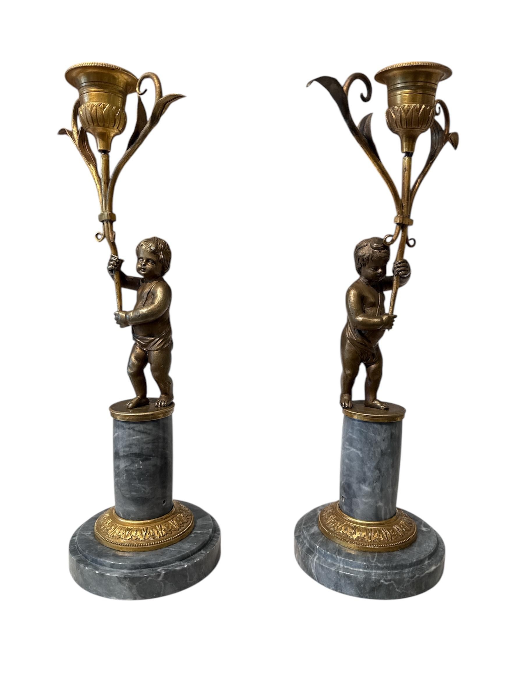 Candle holders in grey marble with gilded frames putti in bronze 