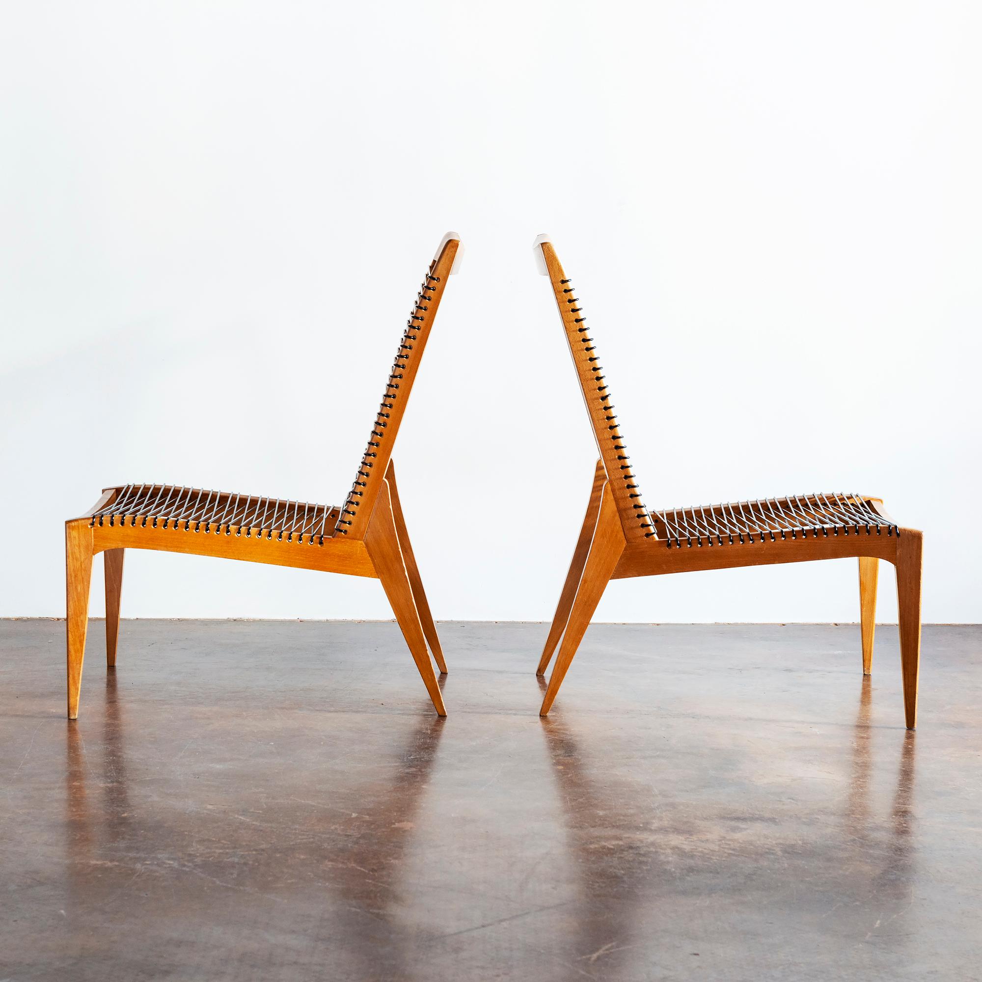 A pair of elegant Louis Sognot lounge chairs in oak and cord, France, 1950s.