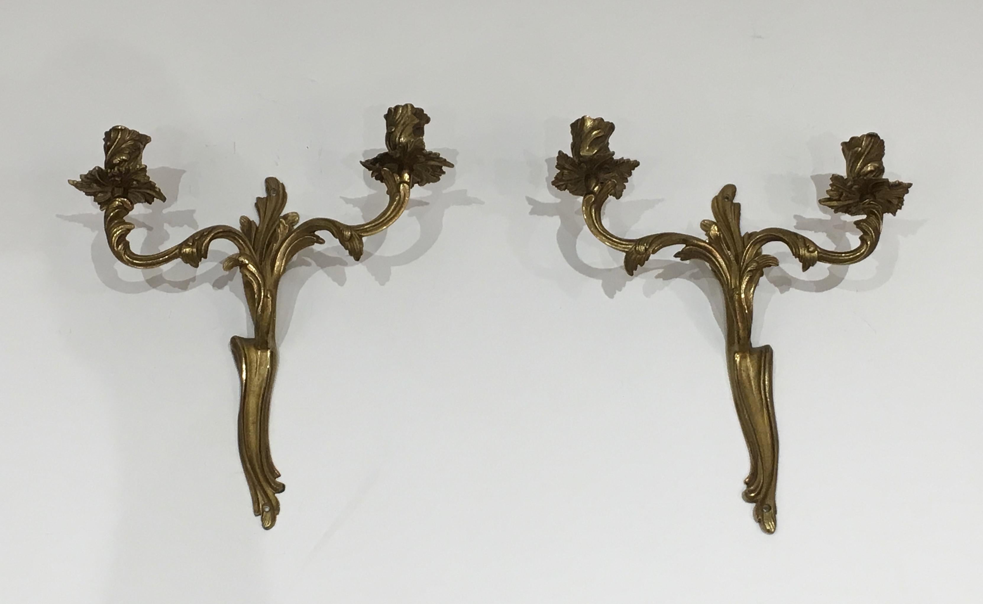 This pair of Louis the 15th style wall lights are made of bronze. This is a French work, circa 1950.
