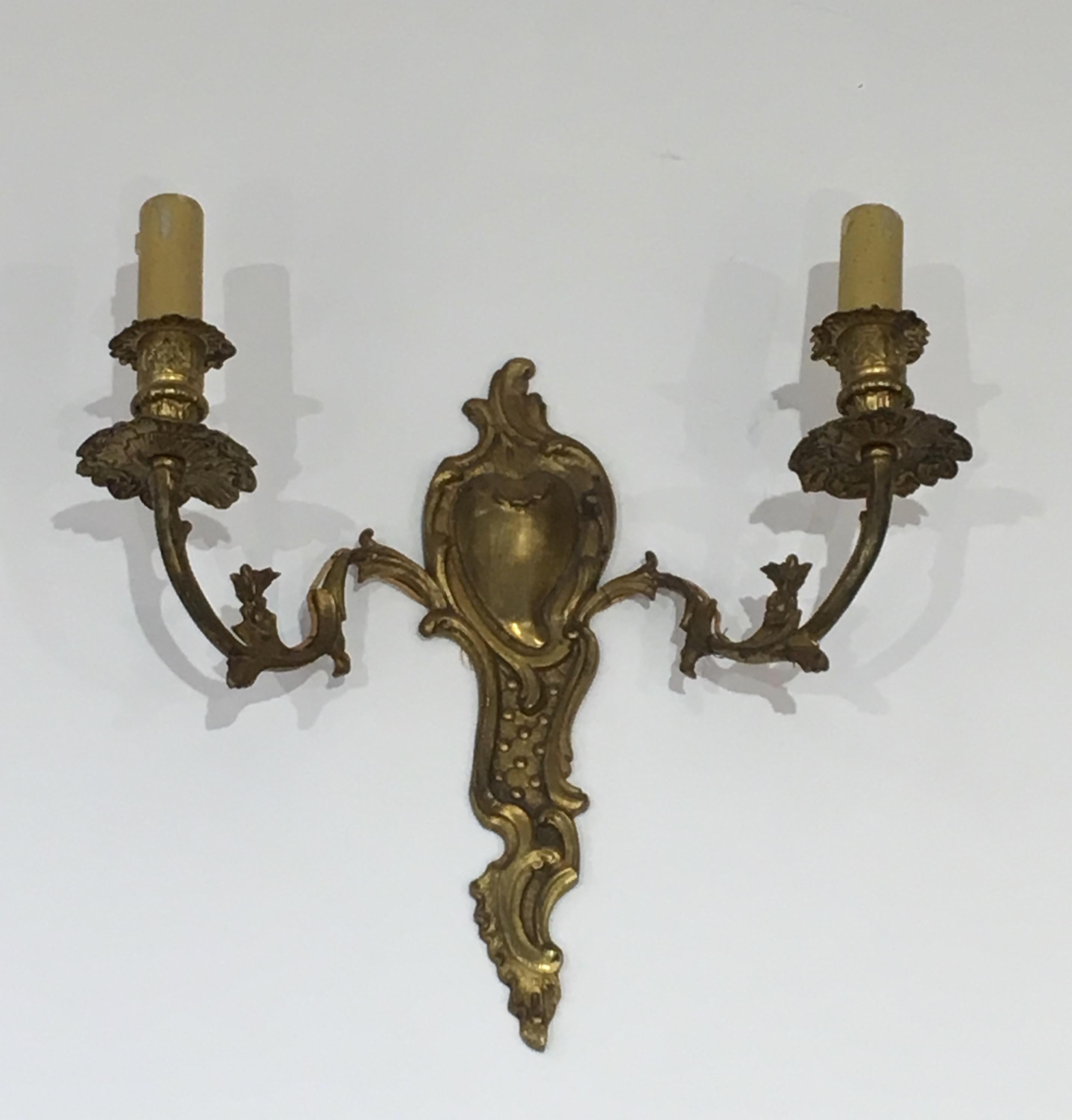This nice pair of Louis the 15th style wall sconces is made of bronze. This is a French work, circa 1920.