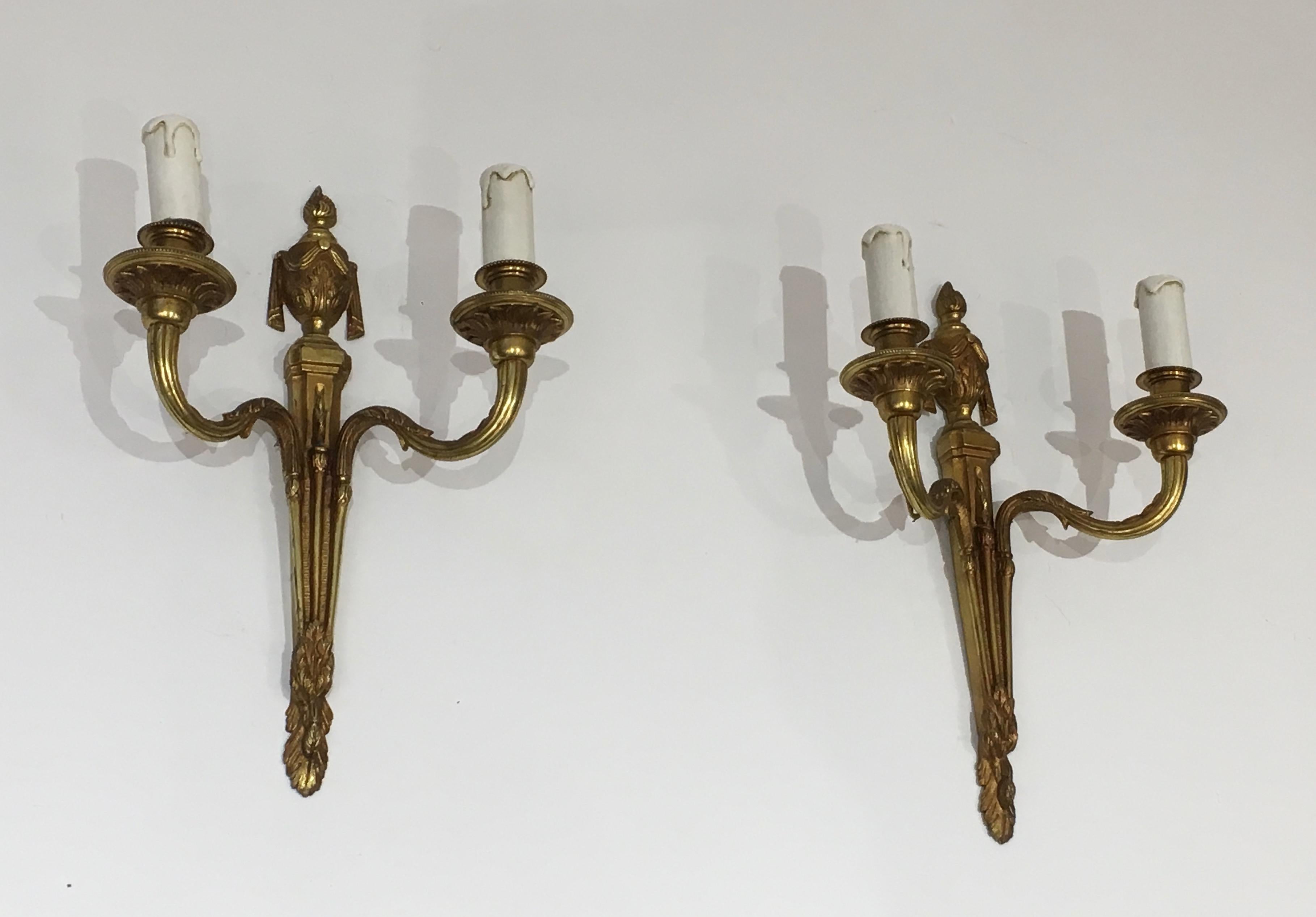 This pair of Louis the 16th century style wall sconces is made of chiseled bronze. This is a French work, circa 1940.