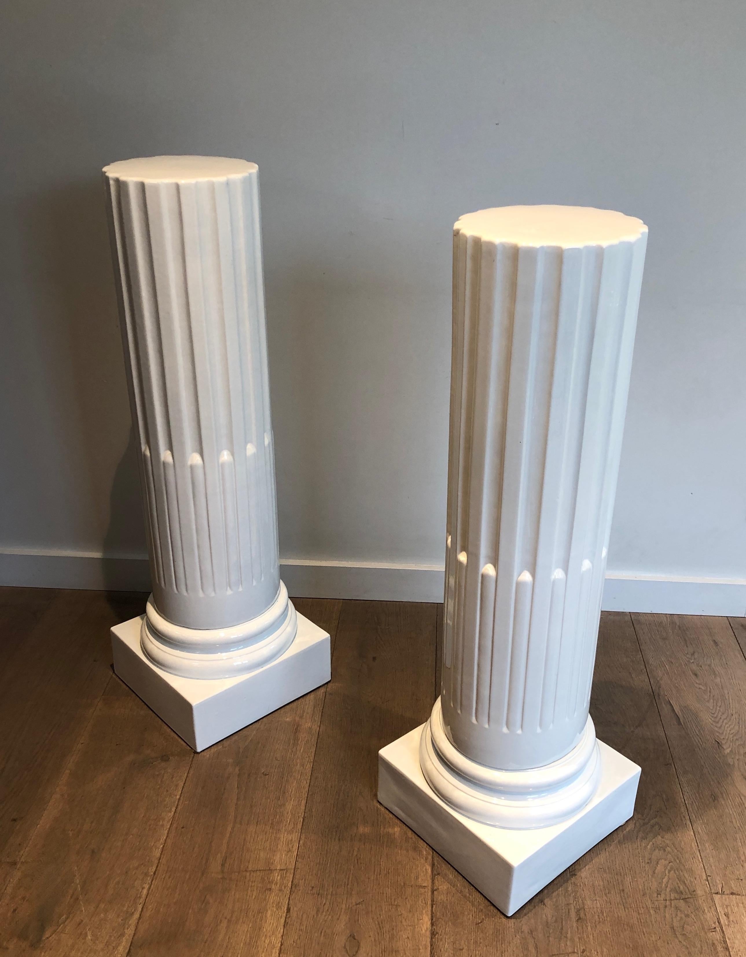 This pair of columns is very unusual. These pedestals are made of a white ceramic. This is a French work in the style of Louis the 16th. Circa 1970