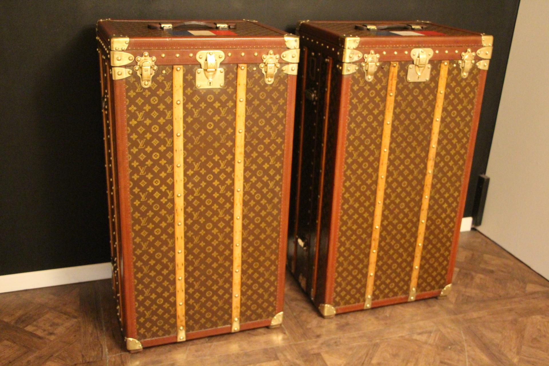 This very rare pair of Louis Vuitton wardrobe features stenciled monogram canvas, rich honey color lozine trims and solid brass locks. Its tops lift up.
Their locks, clasps and studs are marked Louis Vuitton. Their customized French flag painted on