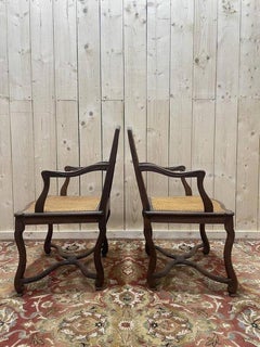 Pair of Louis XIII style armchairs in wood and caning