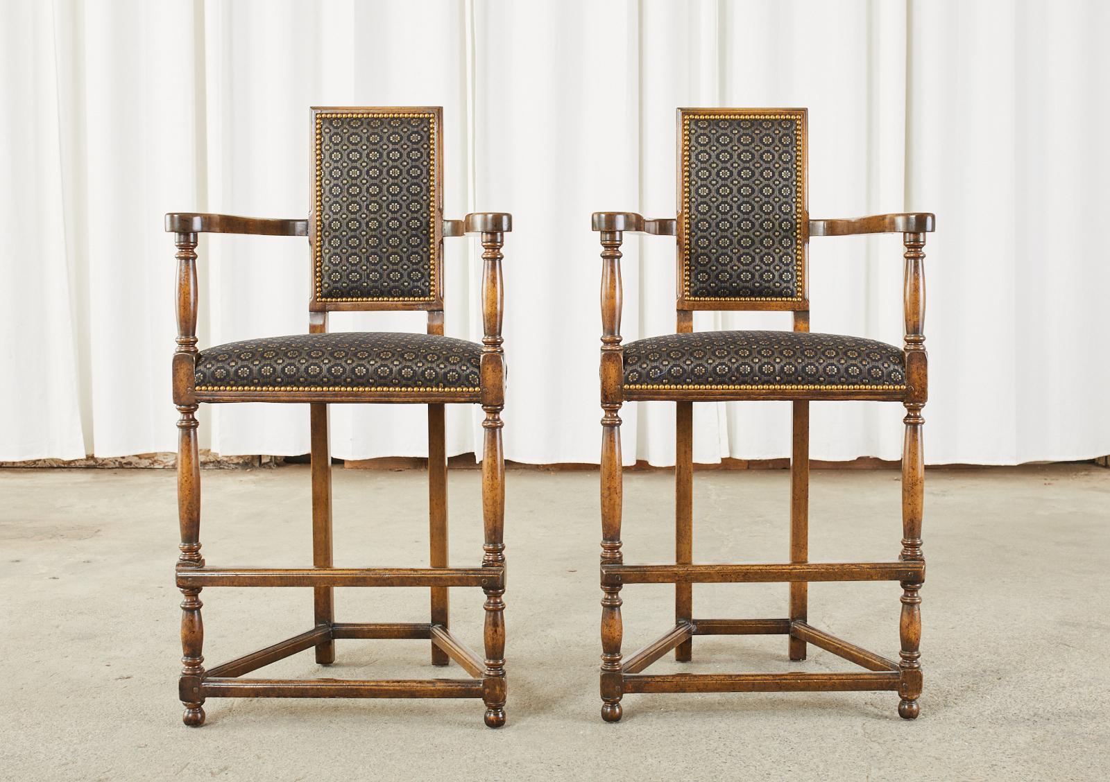 Fabulous pair of walnut barstools designed by Dennis & Leen in the manner of 17th century French Louis XIII. The frames have a triangular form constructed with wood peg joinery. The unique square back conjoins to gracefully curved arms with scrolled