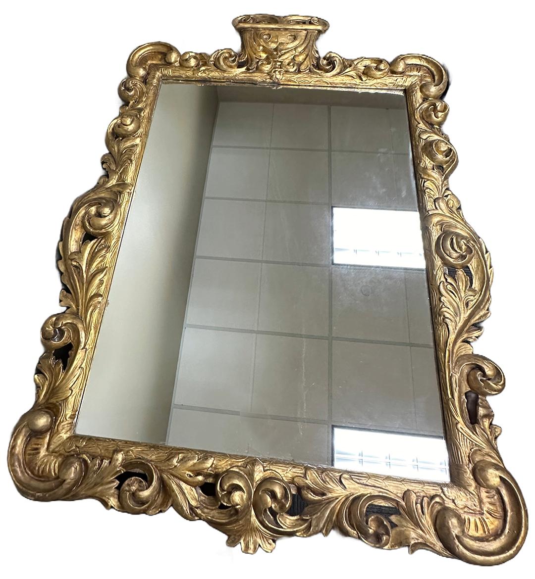 An elegant pair of Louis XIV carved baroque giltwood mirrors,. Highly skilled organically carved floral ornamentation with a crown molding on the top of each mirror. Plywood on back with D rings ready for installation. Made circa 1700 in France.