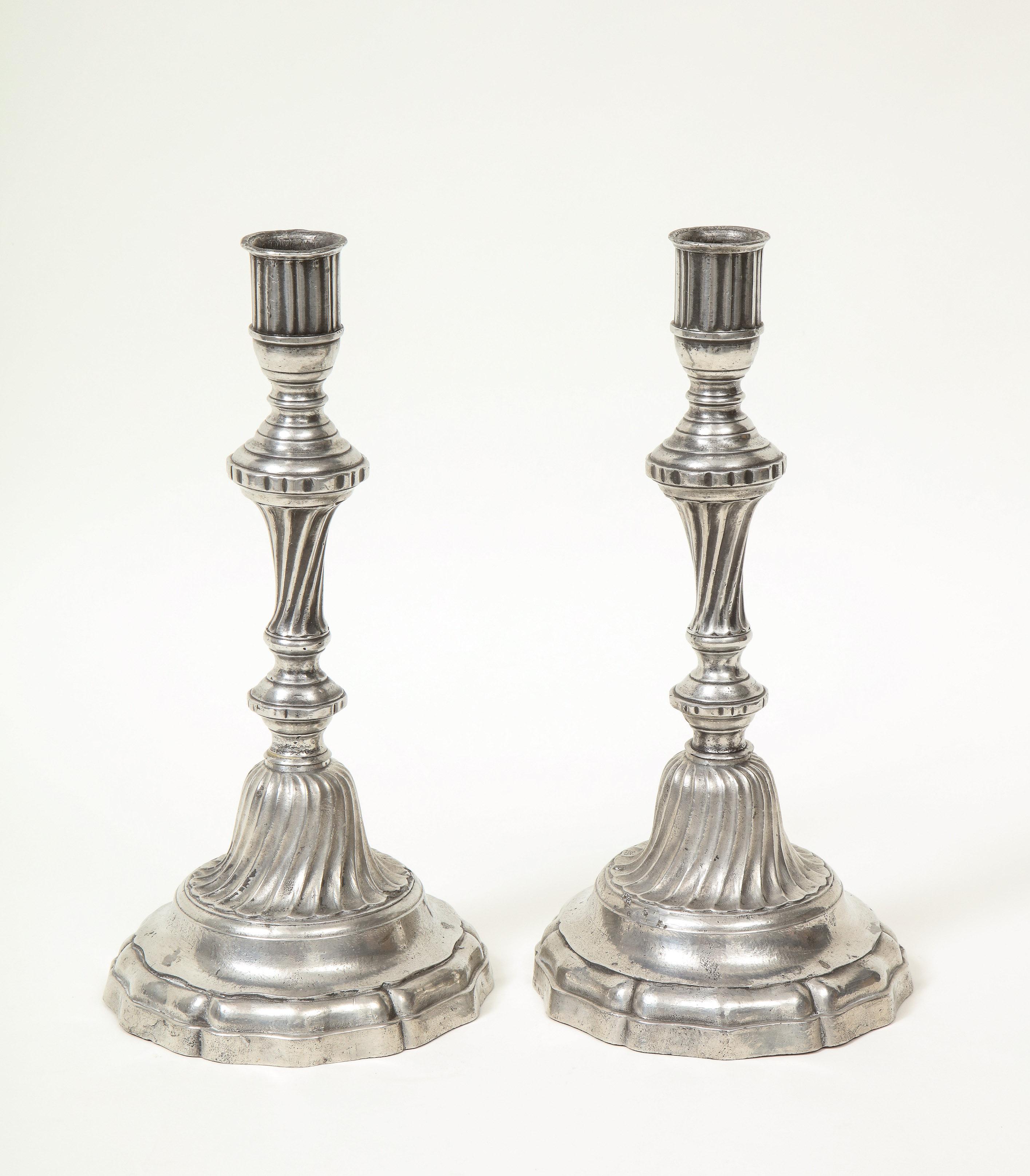Exemplifies the Classical Baroque period with its spiral fluting detail and contrasting patina.