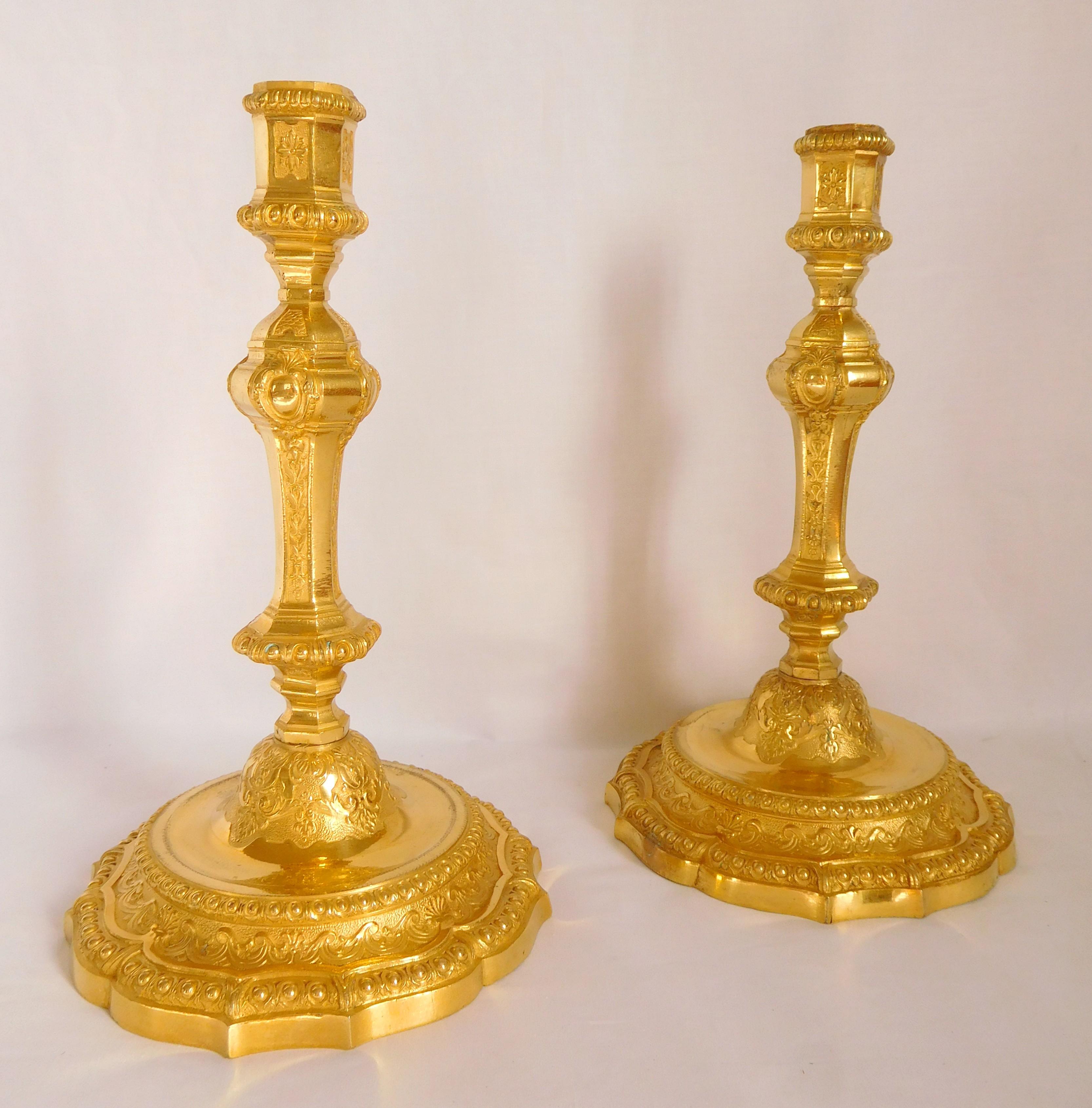 Antique French pair of candlesticks, beautiful ormolu (gilt bronze) set, finely chiseled Louis XIV style or Regency style pattern (early 18th century style). Our model is richly ornamented with pearls, gadroons, curls, acanthus, shells and