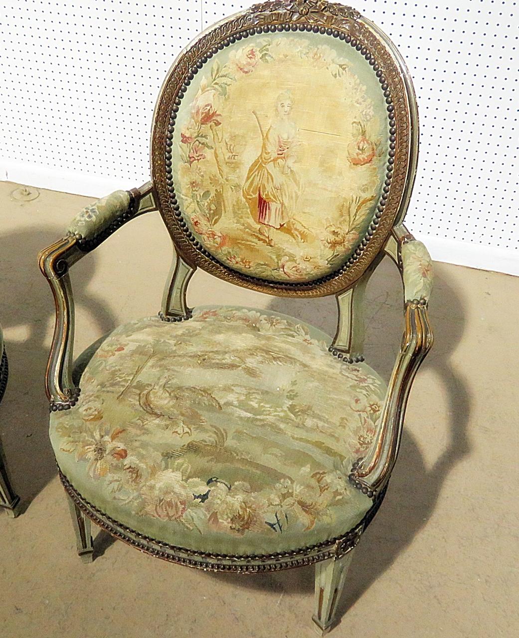Pair of Louis XIV style fauteuils with needlepoint upholstery and nailhead trim.