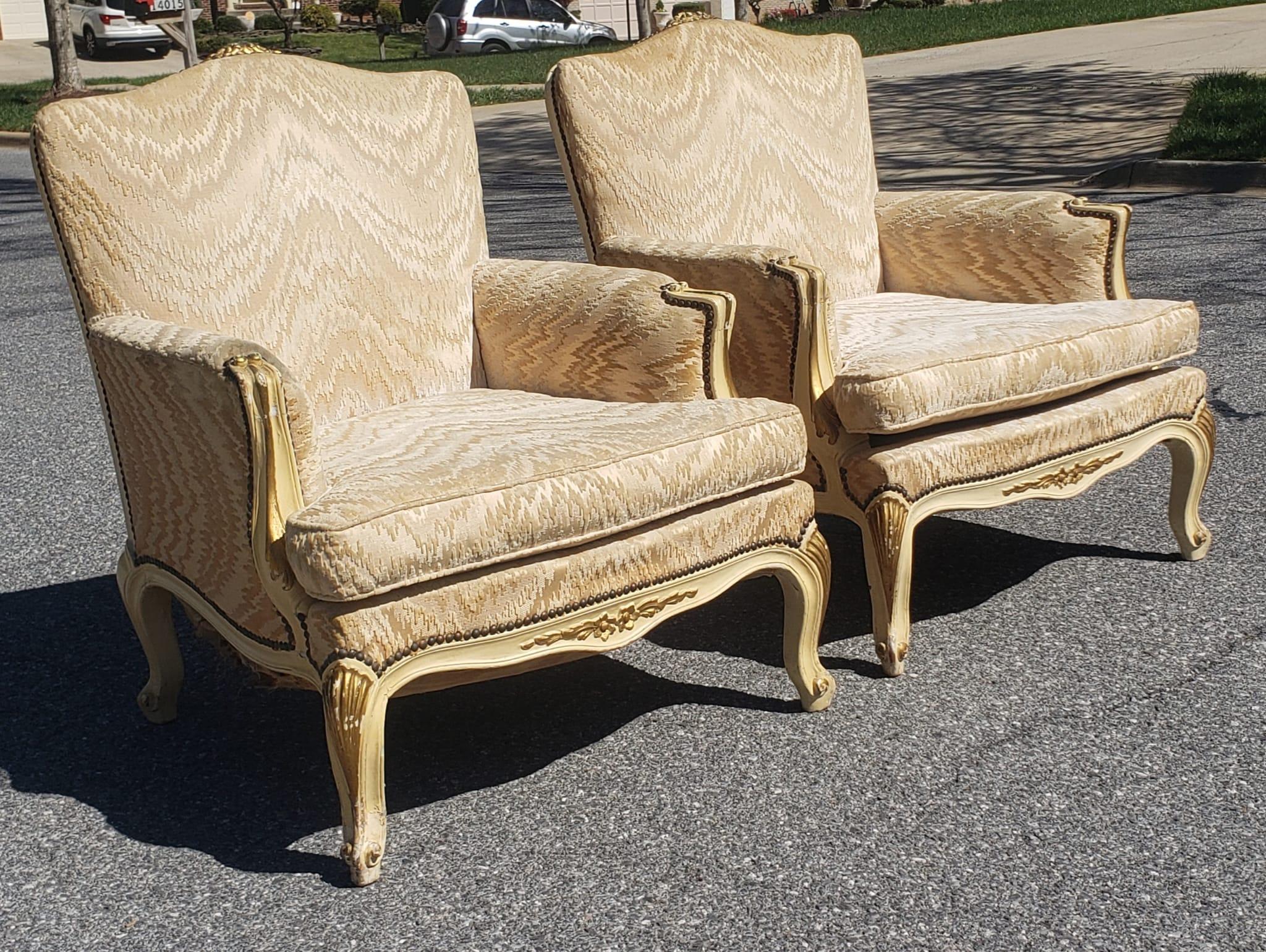 Pair of Louis XV Carved, parcel gilt and Upholstered bergere chairs. High Quality upholstery in very good vintage condition. Very firm and comfortable seats. Measure 29