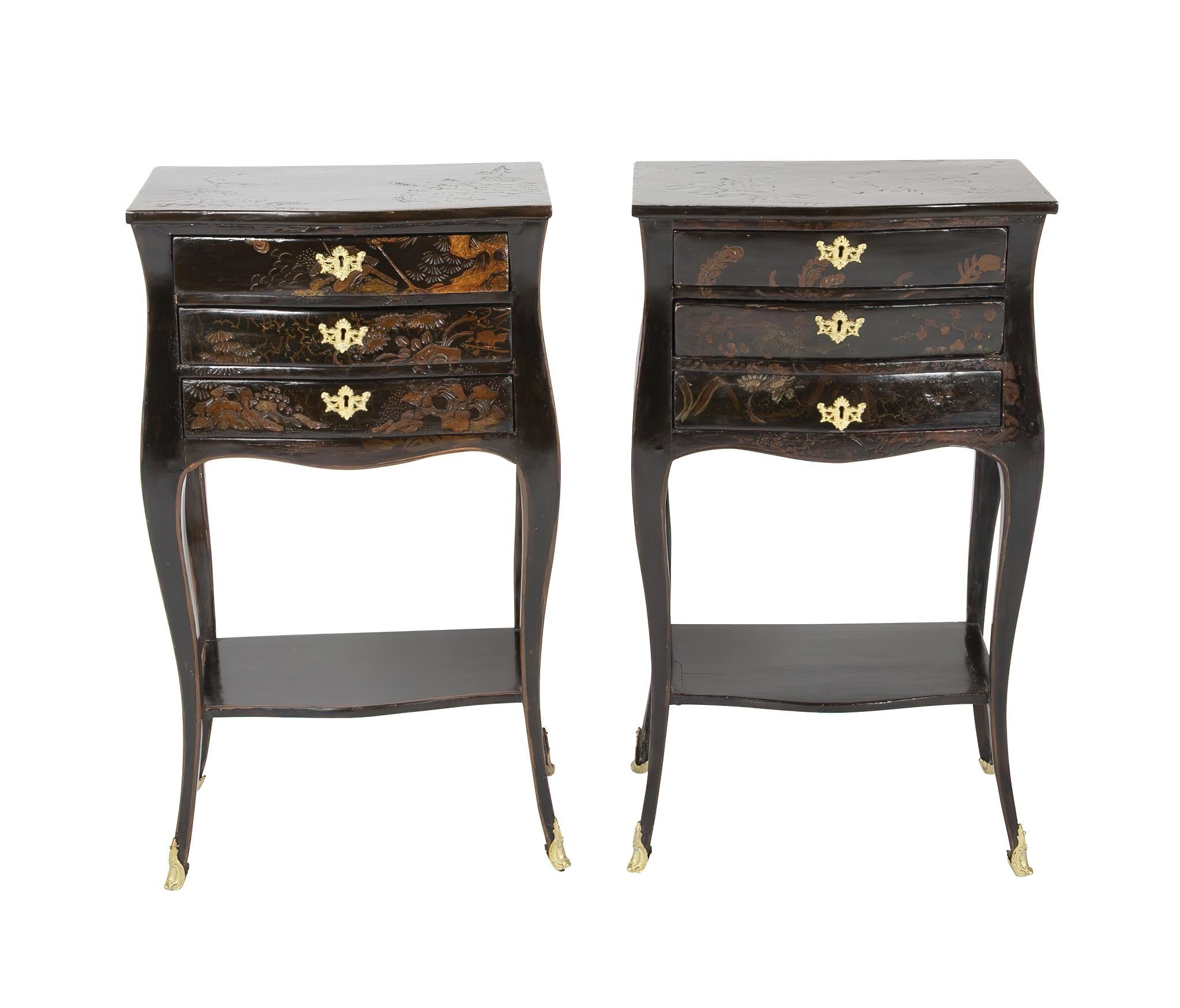 A pair of Louis XV black lacquered petit commodes with chinoiserie decoration. The Bombay and serpentine commodes each have three drawers, cabriole legs, bronze mounts, and a shelf stretcher base.