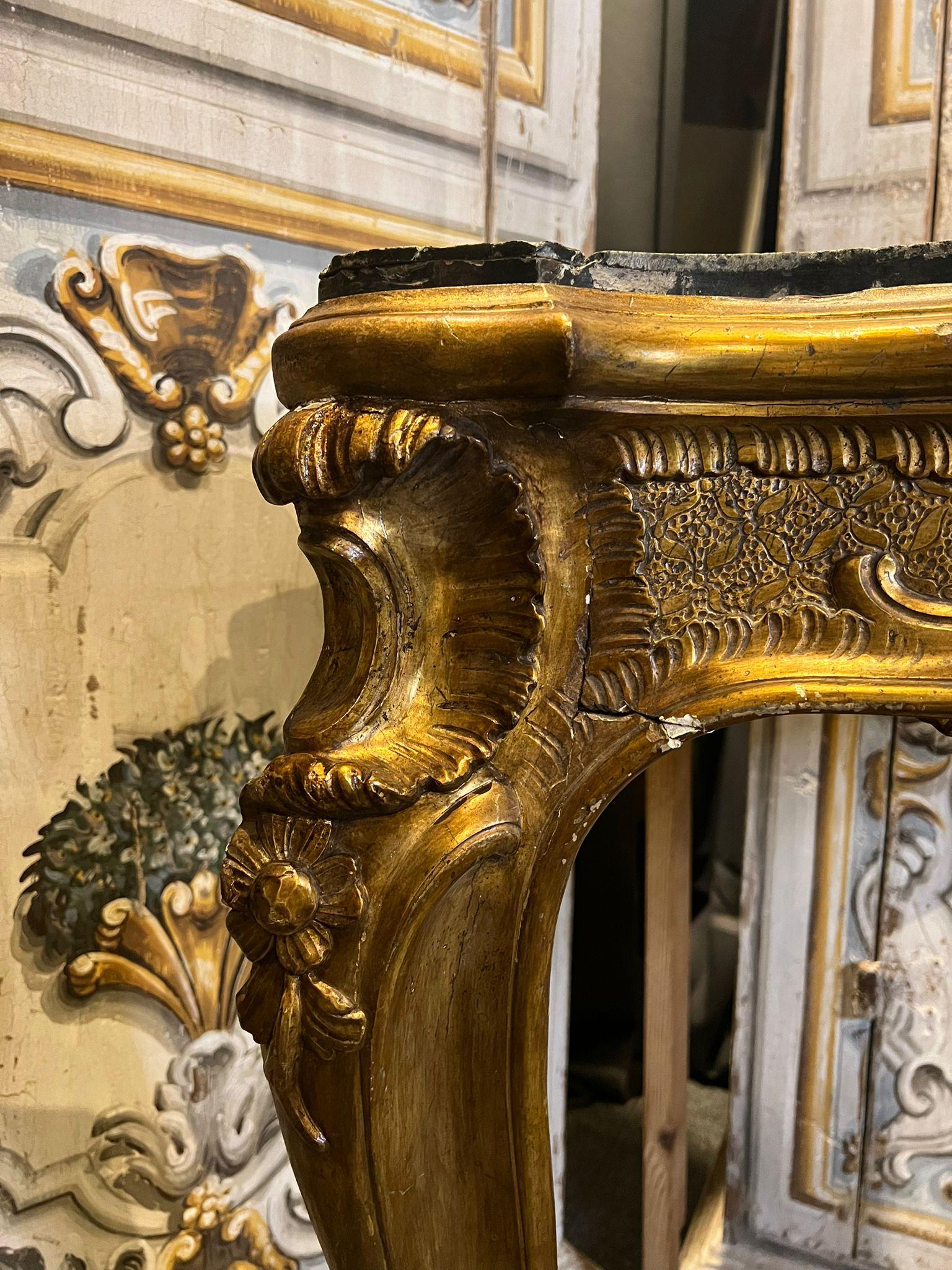Beautiful pair of corner consoles, carved and gilded with mecca, the top is veneered in green and brown marbles. Naples, Louis XV.