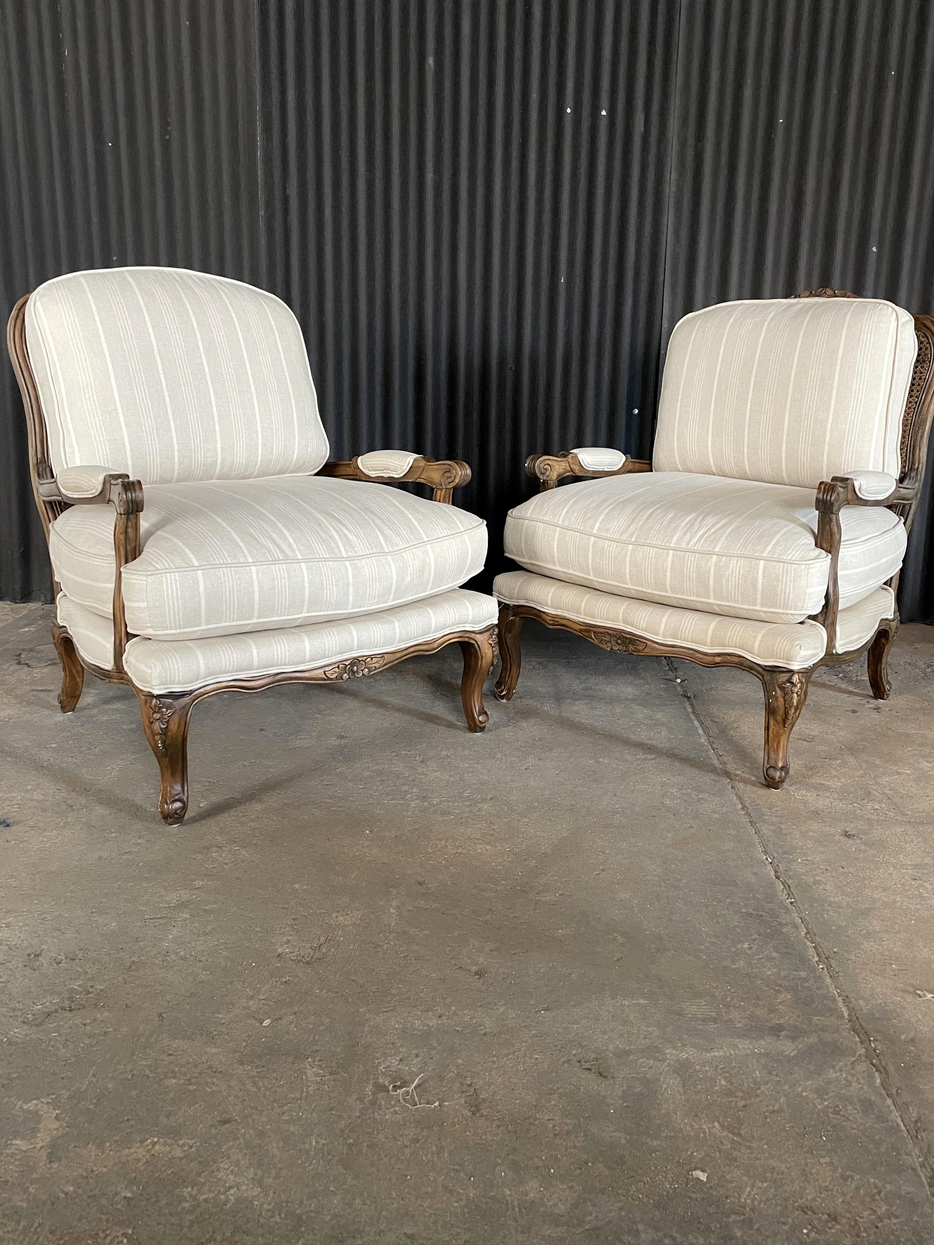 Beautiful pair of Bergère Chairs in gorgeous condition and exceptional detail.
The frames, double cane backing and the upholstery is all in like- new condition.
Wide seating and generously filled cushions make for comfortable seating.
Fabric is an