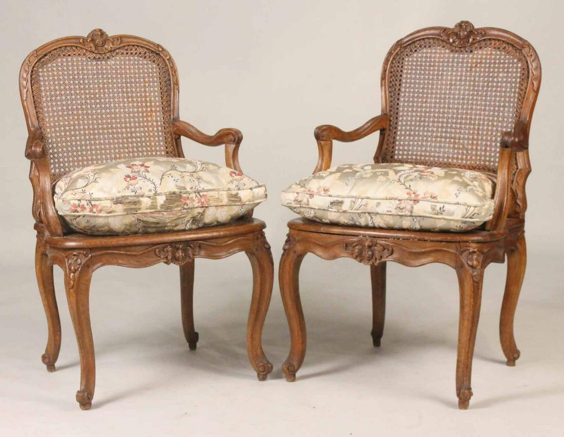 A pair of Louis XV Period fauteuils in beech with caned seats and backs, nicely carved with floral decoration and signed on the underside of the seat rail 