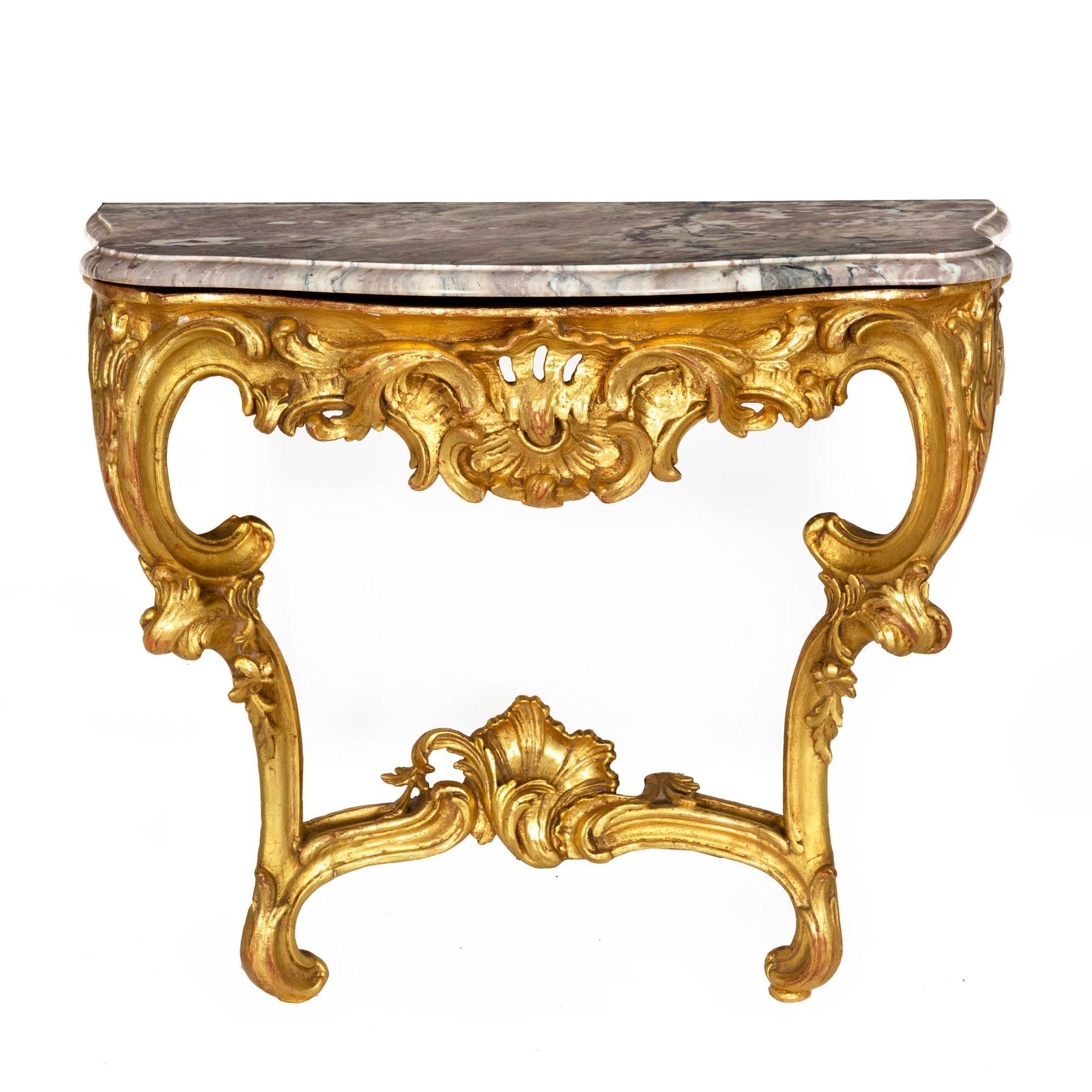 A striking pair of carved giltwood Rococo period console tables with an undulating curvature in the gentle serpentine of the Breccia Medicea marble tops that follows through to the body of each. These gorgeous stones are characterized by hues of