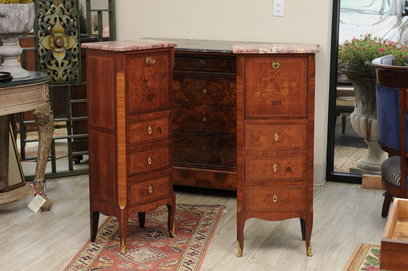 These commodes are simply beautiful !
A highly figured marble top sits on a wood case having a drop down shelf with leather.
Inside is a small drawer and storage space.
Below this are three drawers. The entire front has beautiful inlay decorated