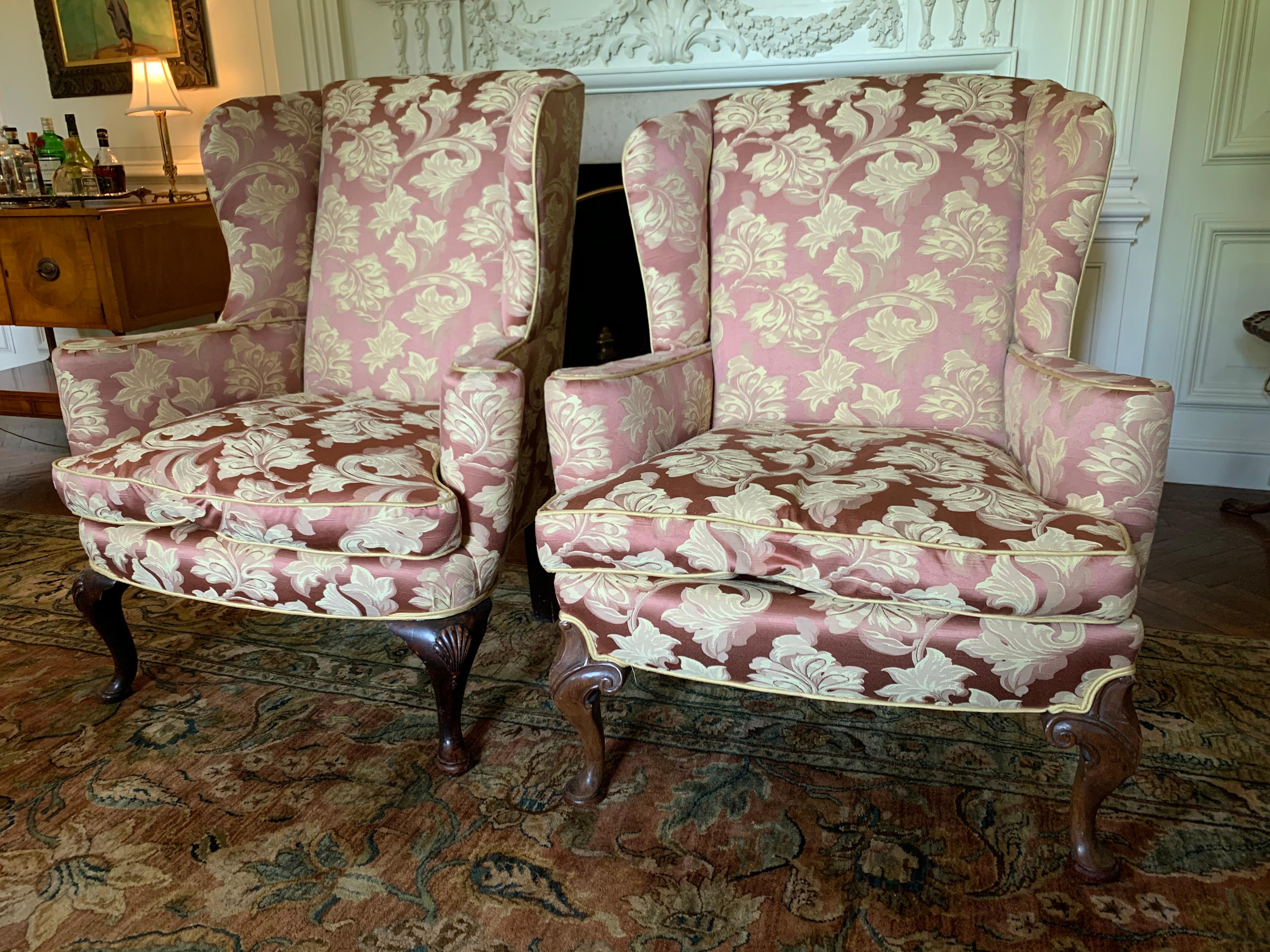 Stunning pair of immense wingback reading chairs featuring a ultra luxurious Scalamandre fabric and
mahogany ball and claw feet. The scale of these chairs is on the larger side, please see dimensions
below. They are very grand indeed.