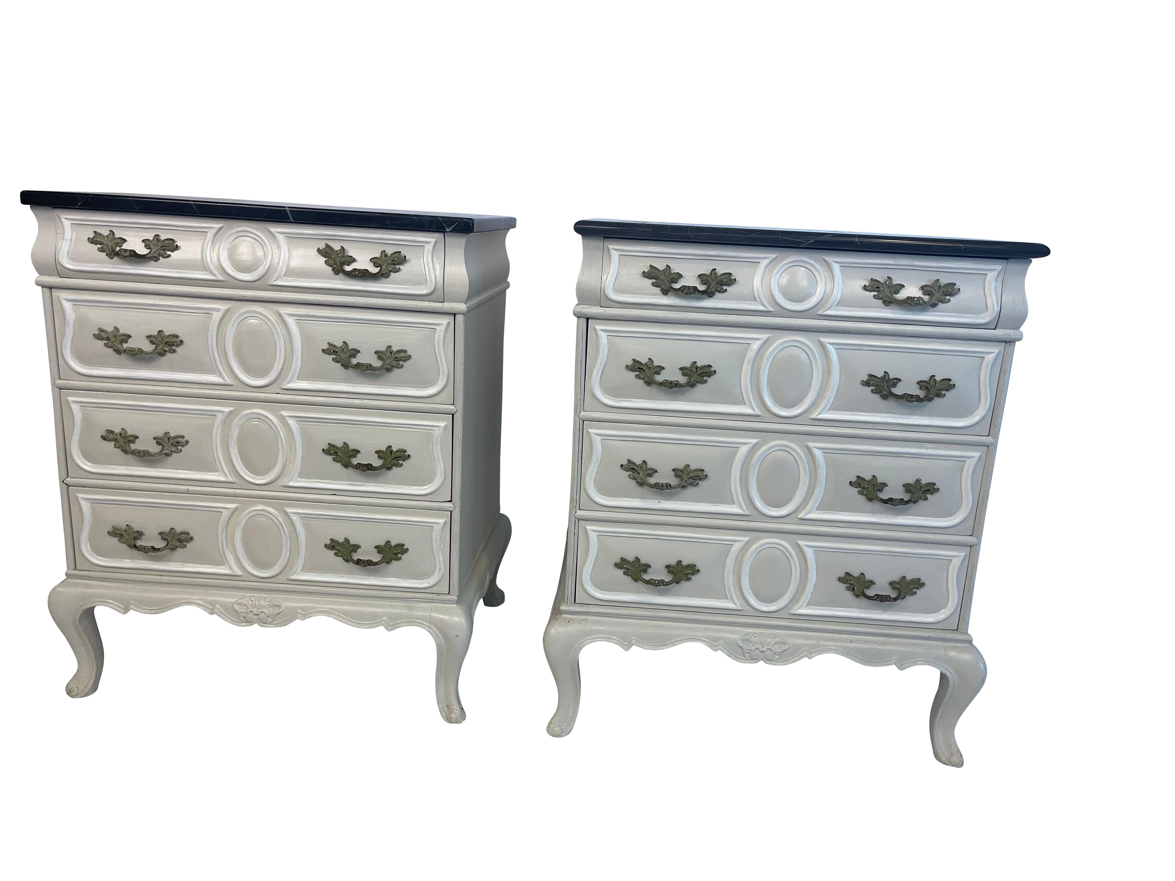 Antique pair of French style paint decorated bed side tables with marble tops. Painted in grey with white decorative trim. Mis matched marble tops.
