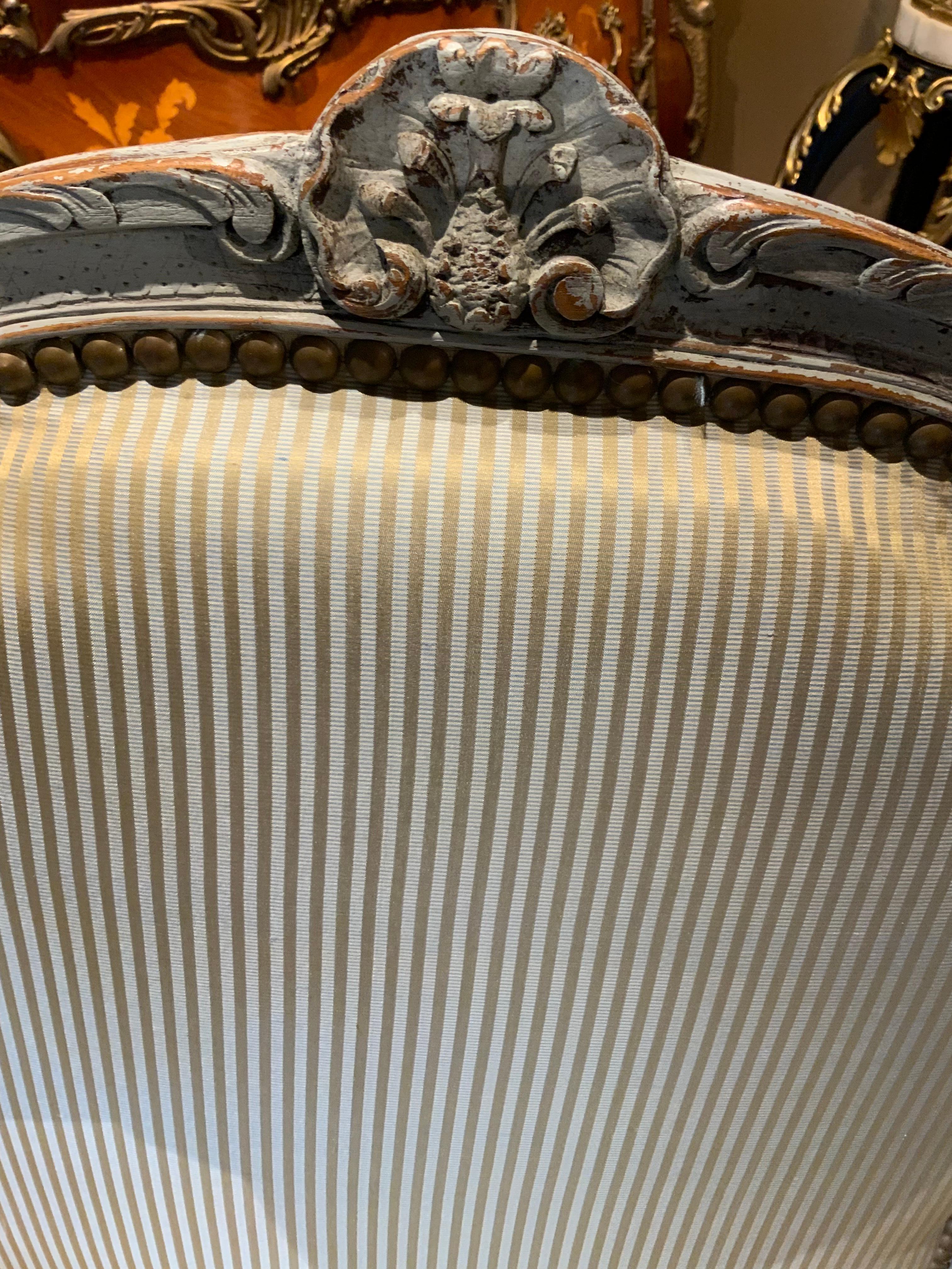 Pair of painted arm chairs with silk striped fabric in louis XV-Style. Having a beautiful 
Cartouche at the crest and a graceful Cabriole leg. Upholstered in a fine silk striped
Fabric.