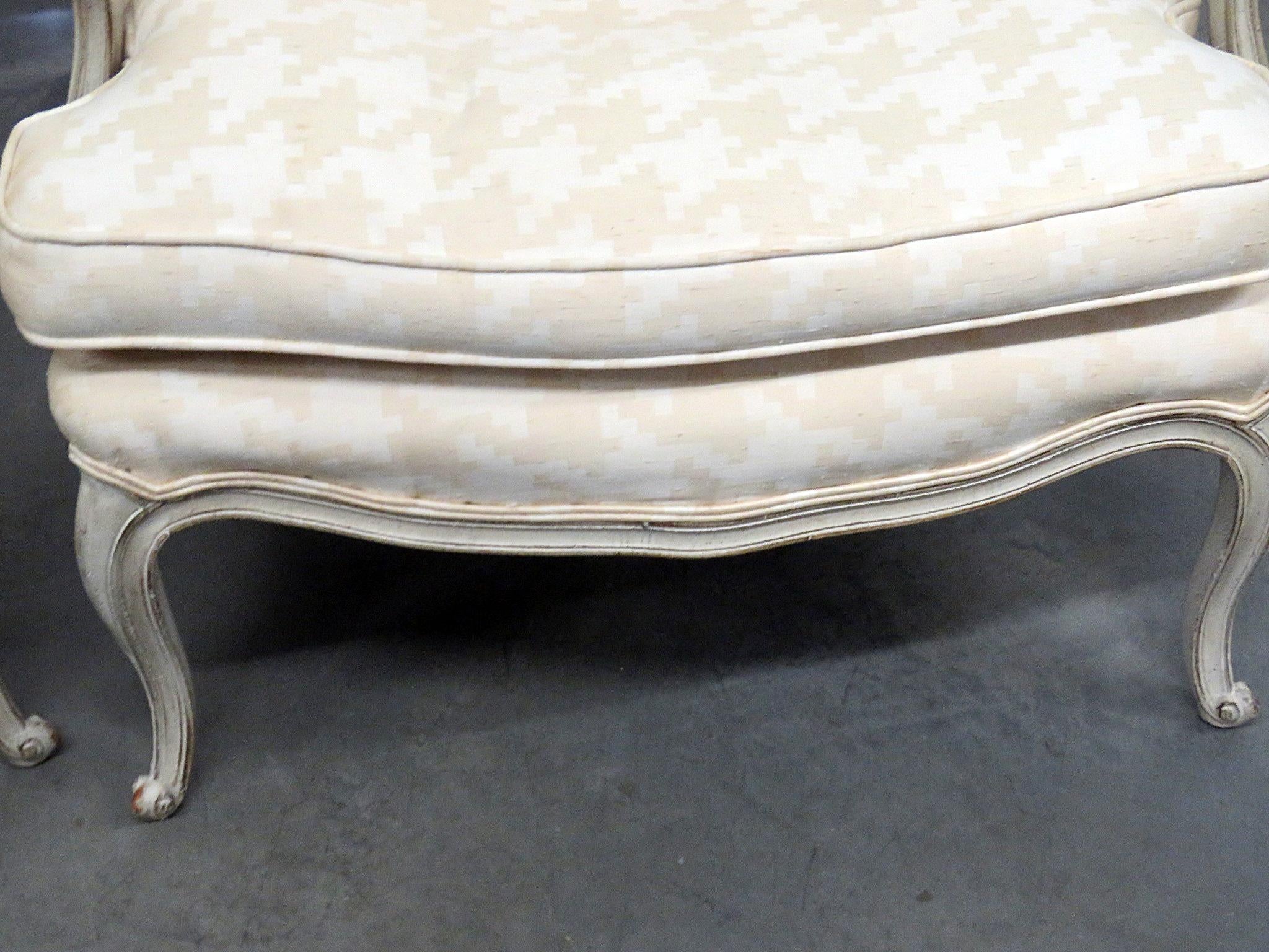 Pair of Louis XV style distressed finished armchairs with matching accent pillows.