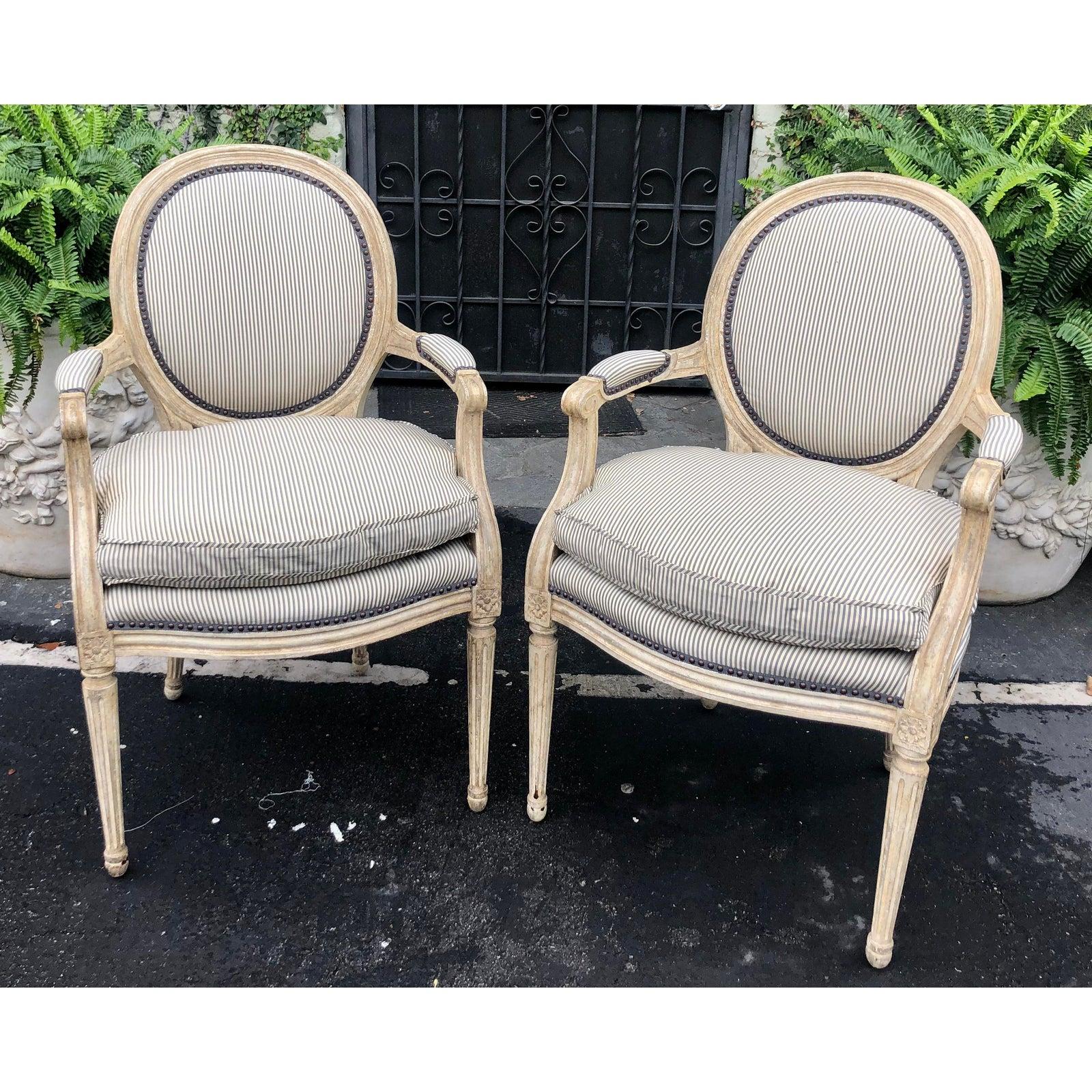 Pair of Louis XV style balloon back armchairs with silk down cushions.