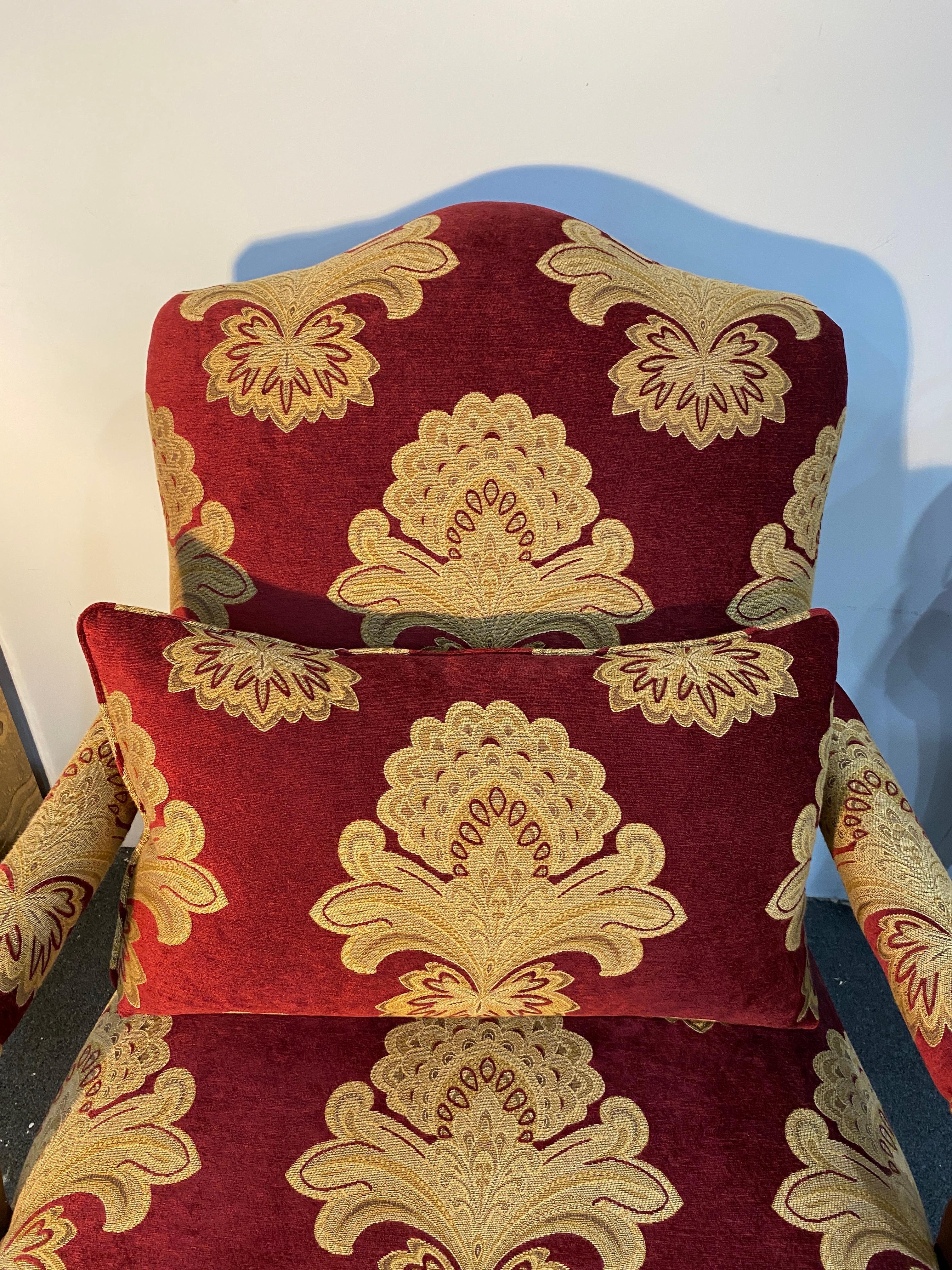 Stunning pair of bergère armchairs or lounge chairs made in the grand French Louis XV style. Featuring large carved frames in the style and scale of a marquise bergère with neoclassical motifs decorating the seat. The back gracefully curves down to