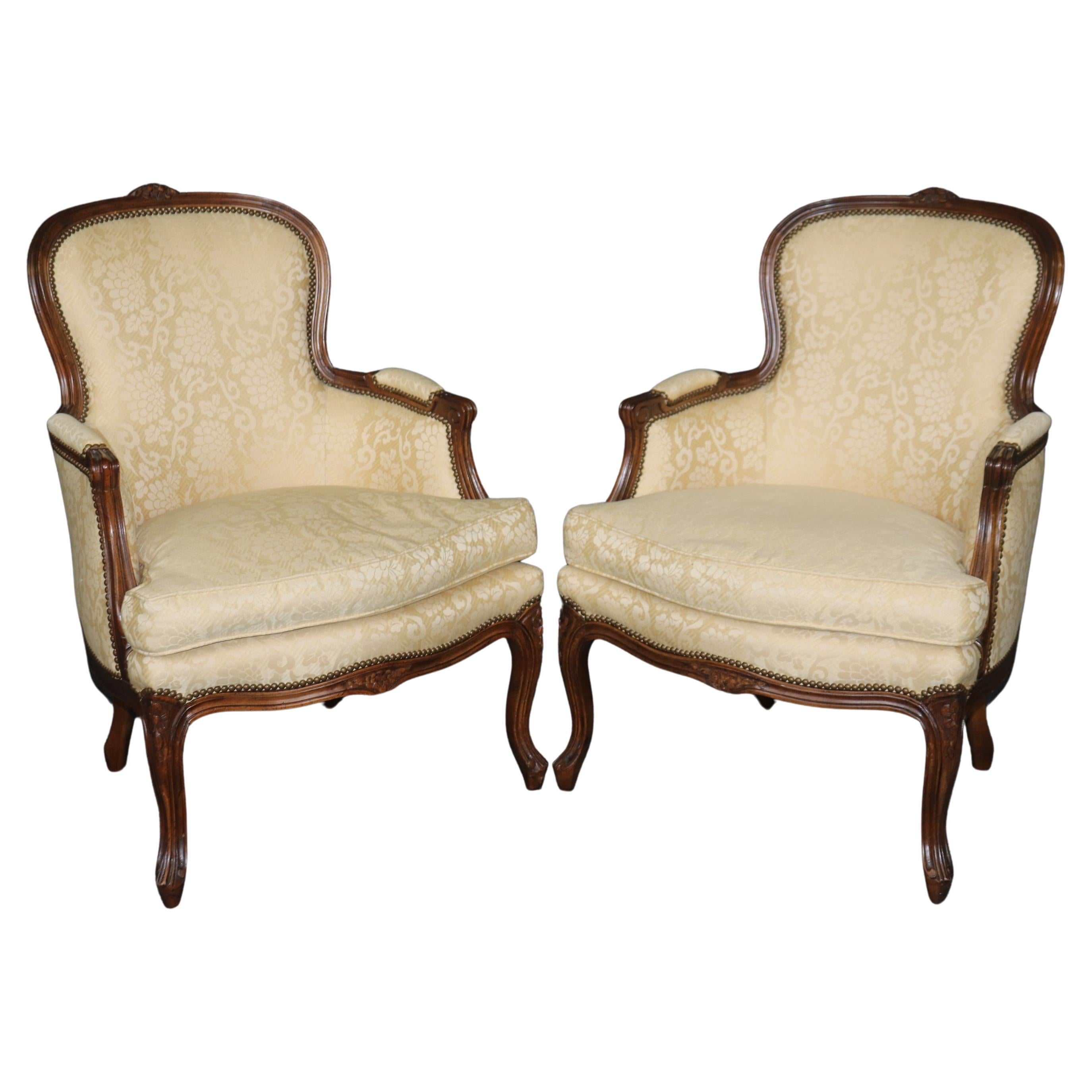 Pair of Louis XV Style Carved Bergeres with Baker Upholstery and Nailhead Trim For Sale
