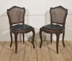 Pair of Louis XV Style Carved Walnut and Caned Side Chairs