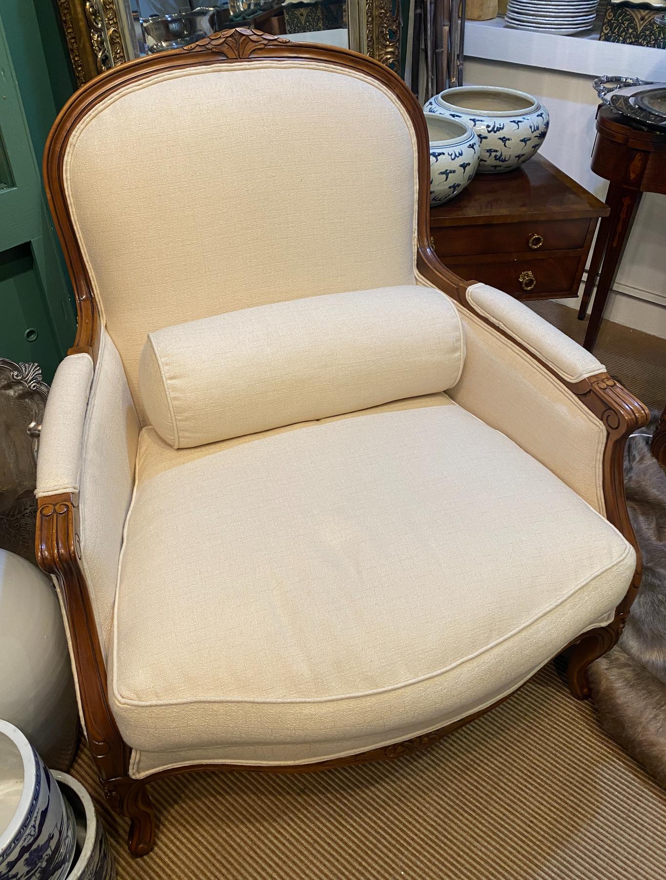 Pair of Louis XV Style cherry wood with white upholstery bergere chairs
Arched padded backs, scrolling padded arms and loose cushion seats. Carved molded frame with leaf-like motif on cabriole legs and scrolling feet. Upholstery color: Cream. Very