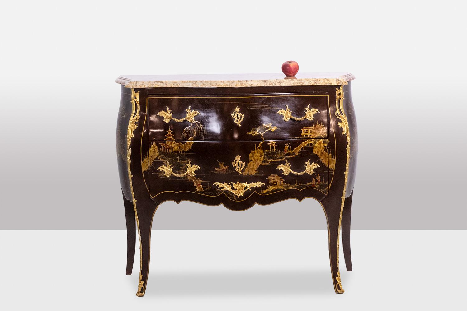 Pair of Louis XV and Asian style “sauteuse” chests of drawers, in lacquer and gilt bronze, with their marble tops, lacquer decorated with landscapes composed of pagodas, trees, bridges, and figures, some figures on boats. Original keys.

French work