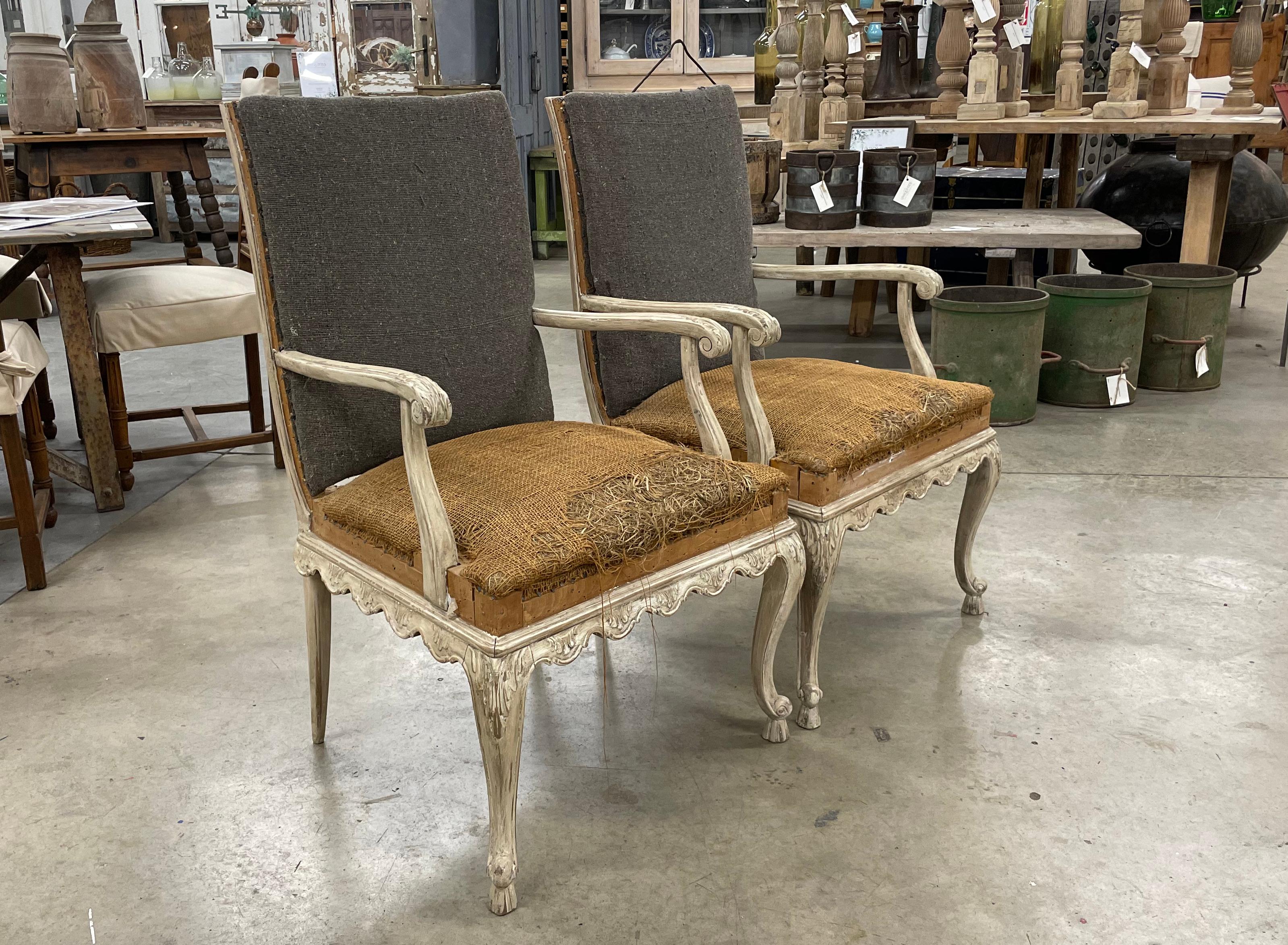 Pair of carved antique Louis XV style fauteuil armchairs. The chairs are very comfortable with a generous size seat and a slight reclined back. 

Beautiful carvings on the both the front cabriole legs and the shaped armrests with acanthus leaf