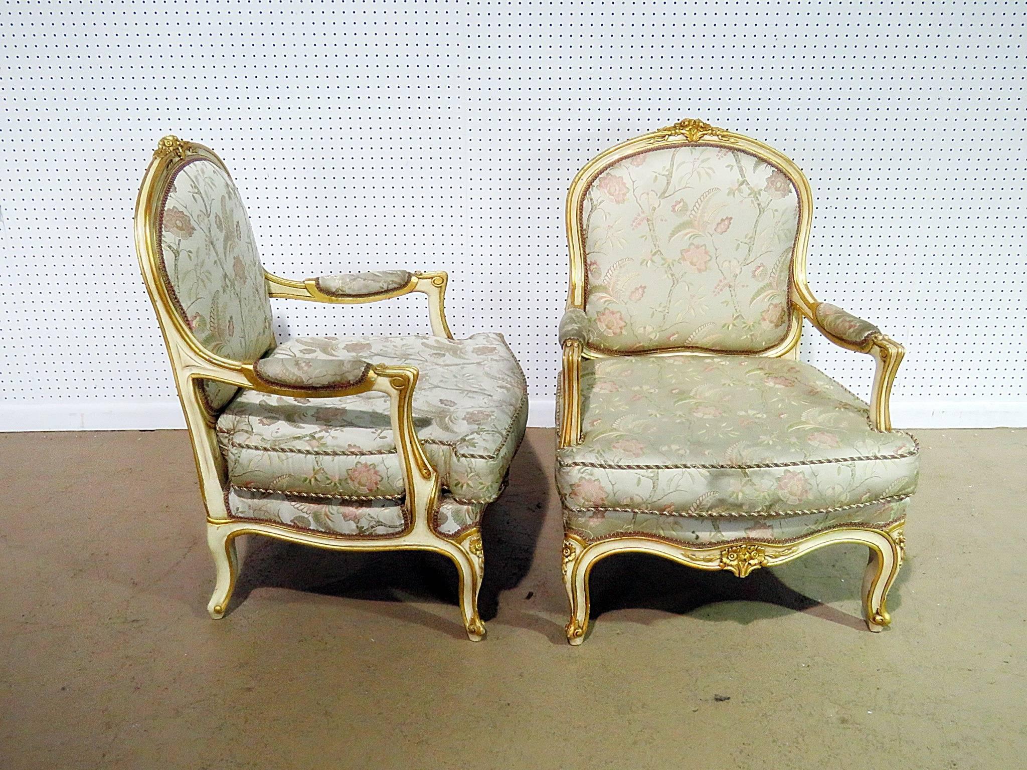 Pair of Louis XV style distressed painted fauteuils with gilt trim.