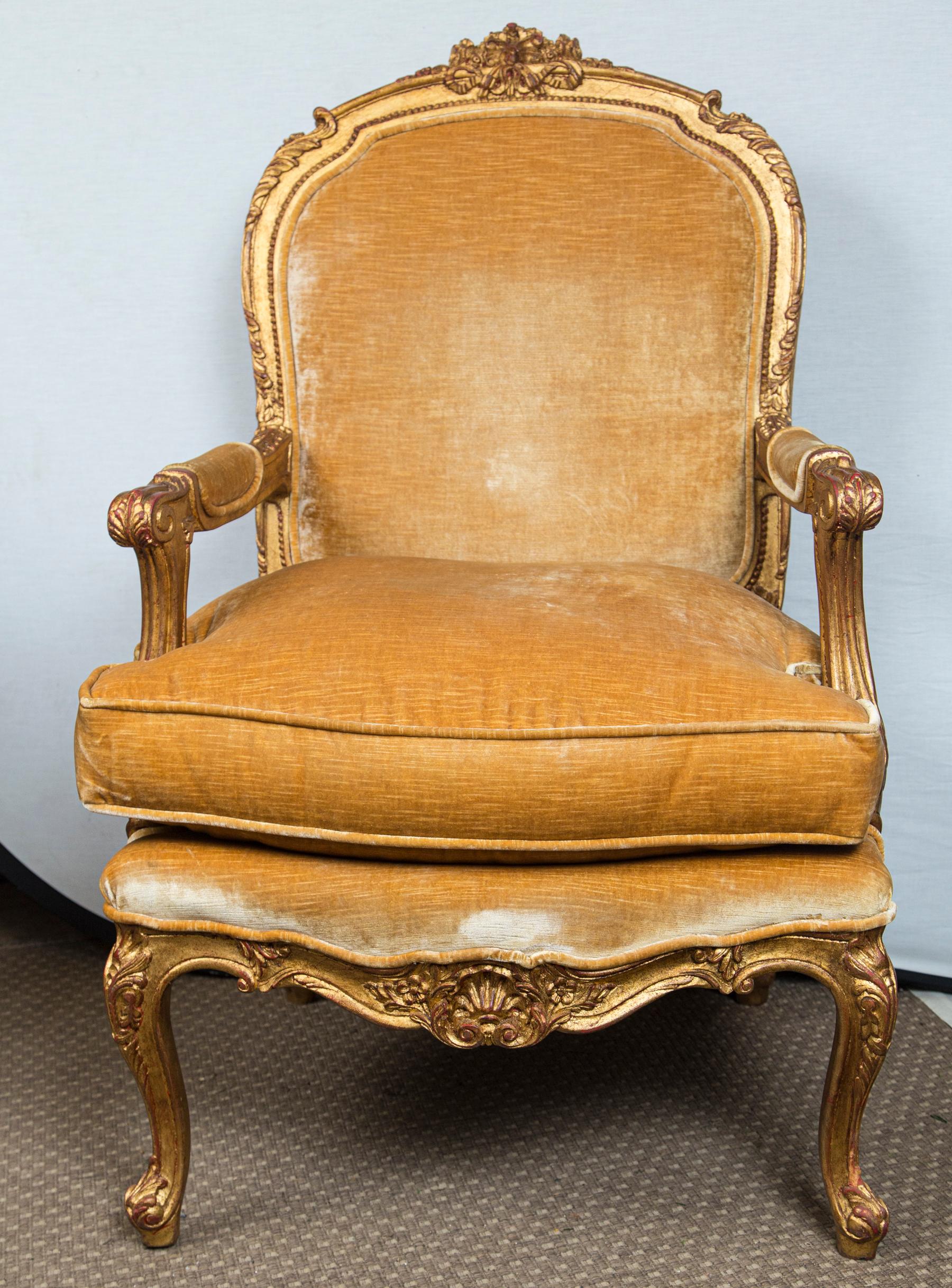 The hand craved frames gilded and painted. Upholstered in gold colored velvet. The areas in the photos that show a white color of the upholstery is the way the fabric photographs at certain angles. They look worn in the photos, but are not.
The